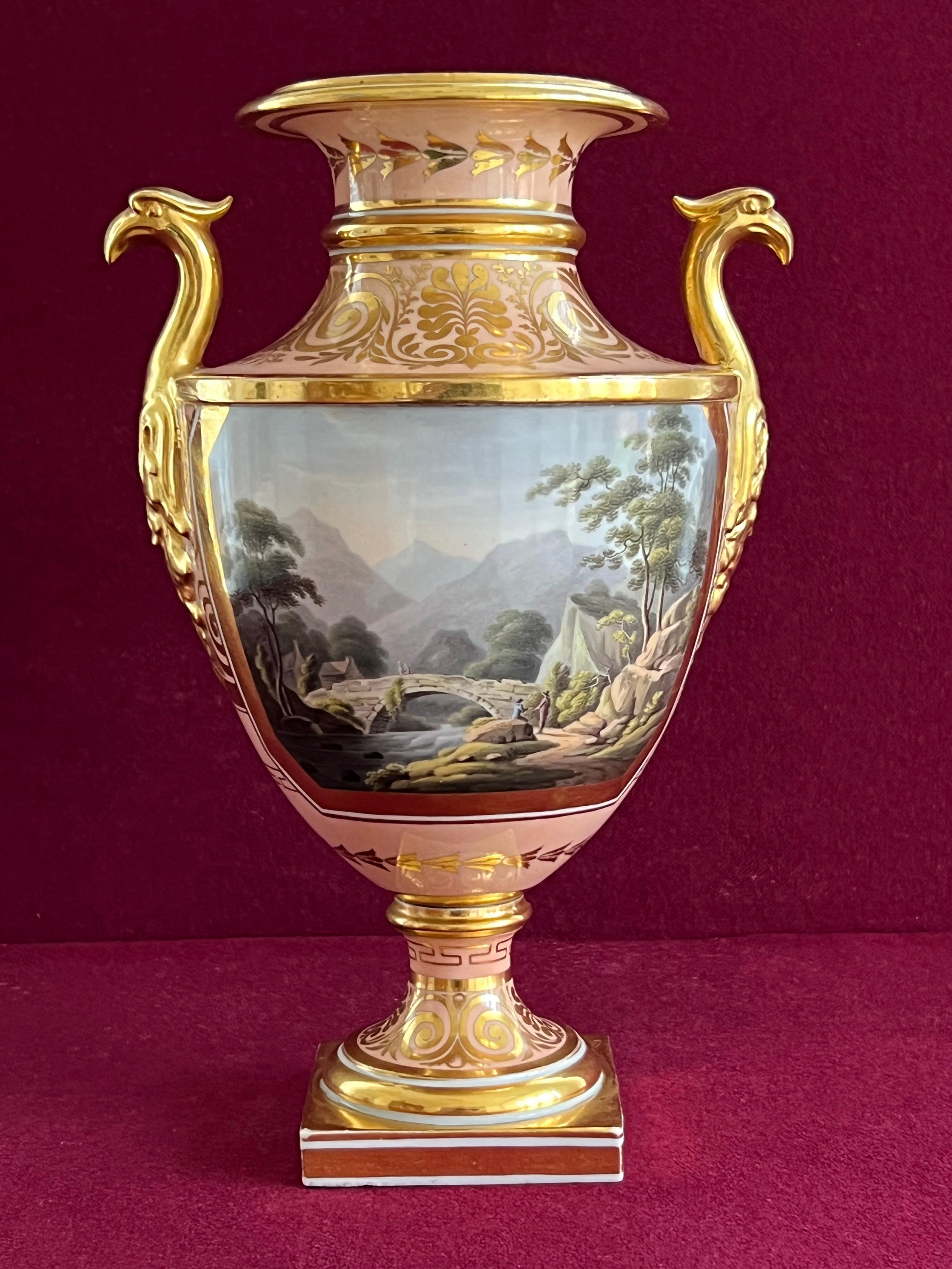 A Barr, Flight & Barr Worcester porcelain vase c.1810. Of classical form, applied with gilt birds' head and foliate handles, painted with a large panel with a titled Welsh view of 'Pont Yr Eden, over the River Mowddrdeh near Dolgelly,