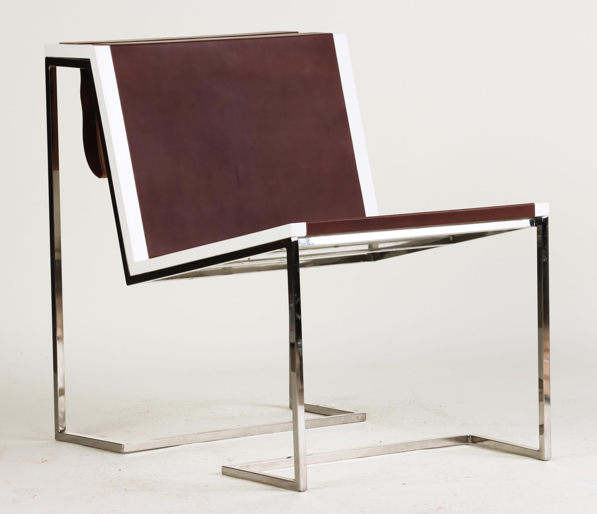 A Bauhaus inspired, contemporary occasional chair with high polished stainless steel base and brown leather seat detail. Leather forms a sling to store books and magazines.