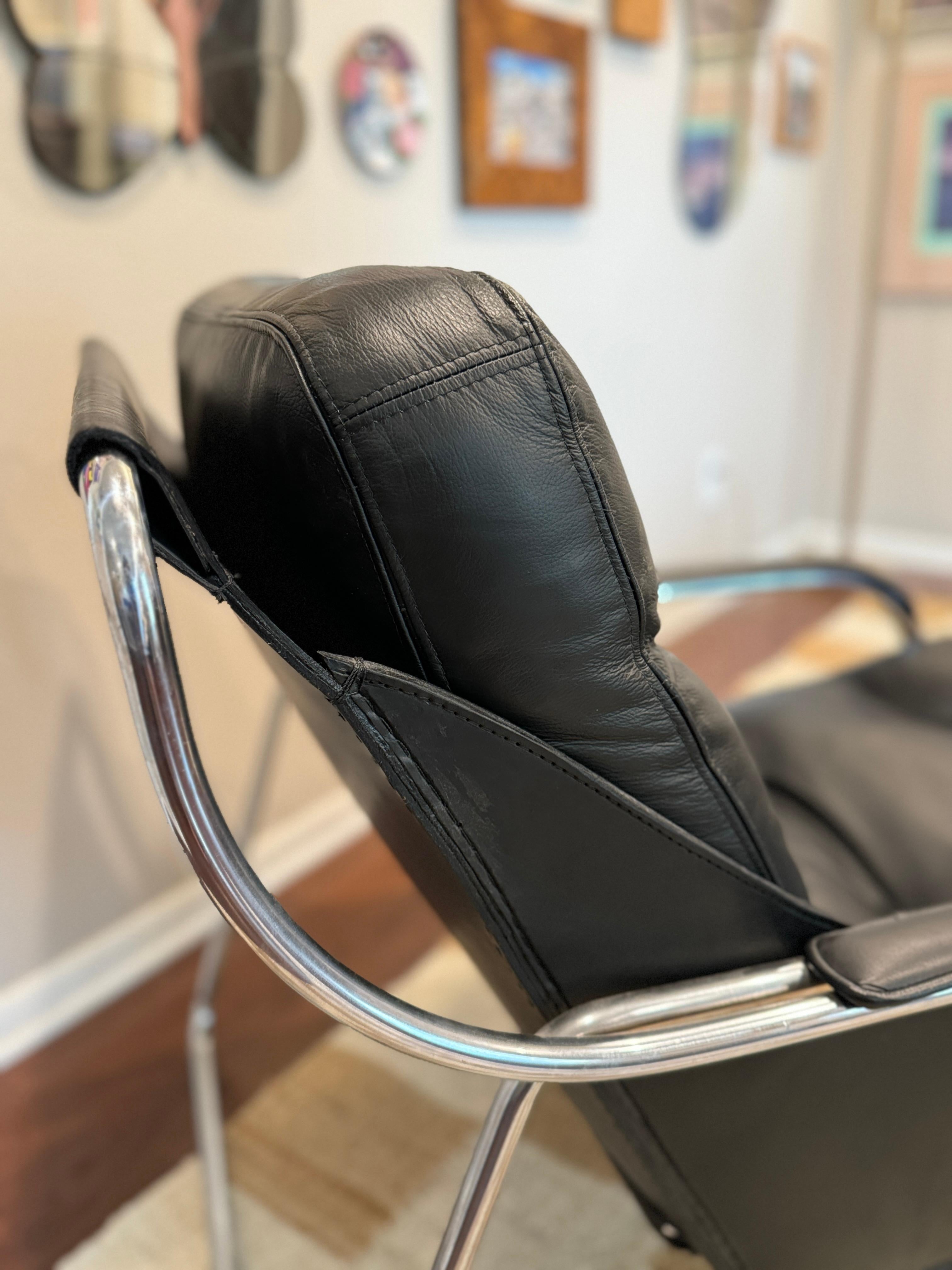 A bauhaus style black leather and chrome lounge chair and ottoman 6