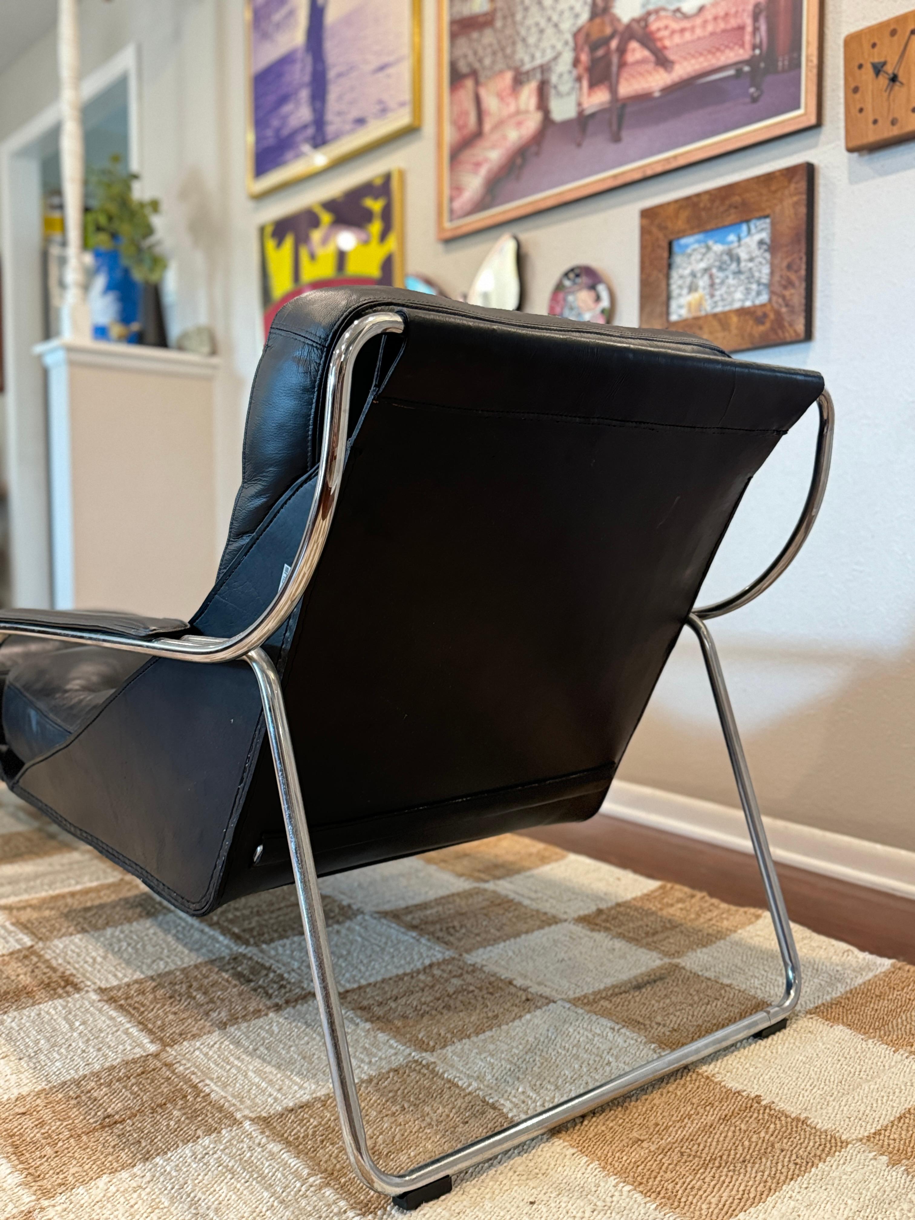 A bauhaus style black leather and chrome lounge chair and ottoman 9