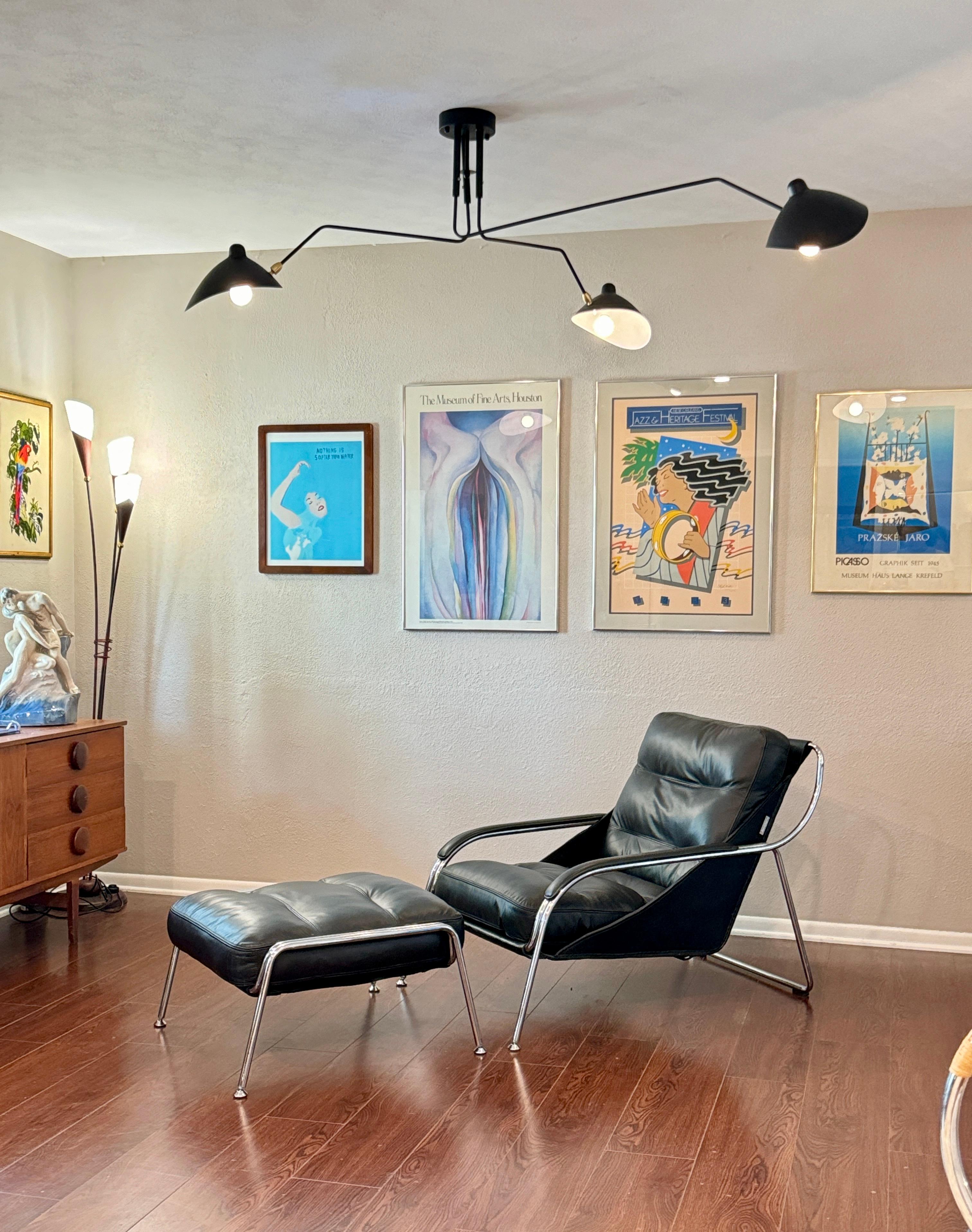 Contemporary A bauhaus style black leather and chrome lounge chair and ottoman
