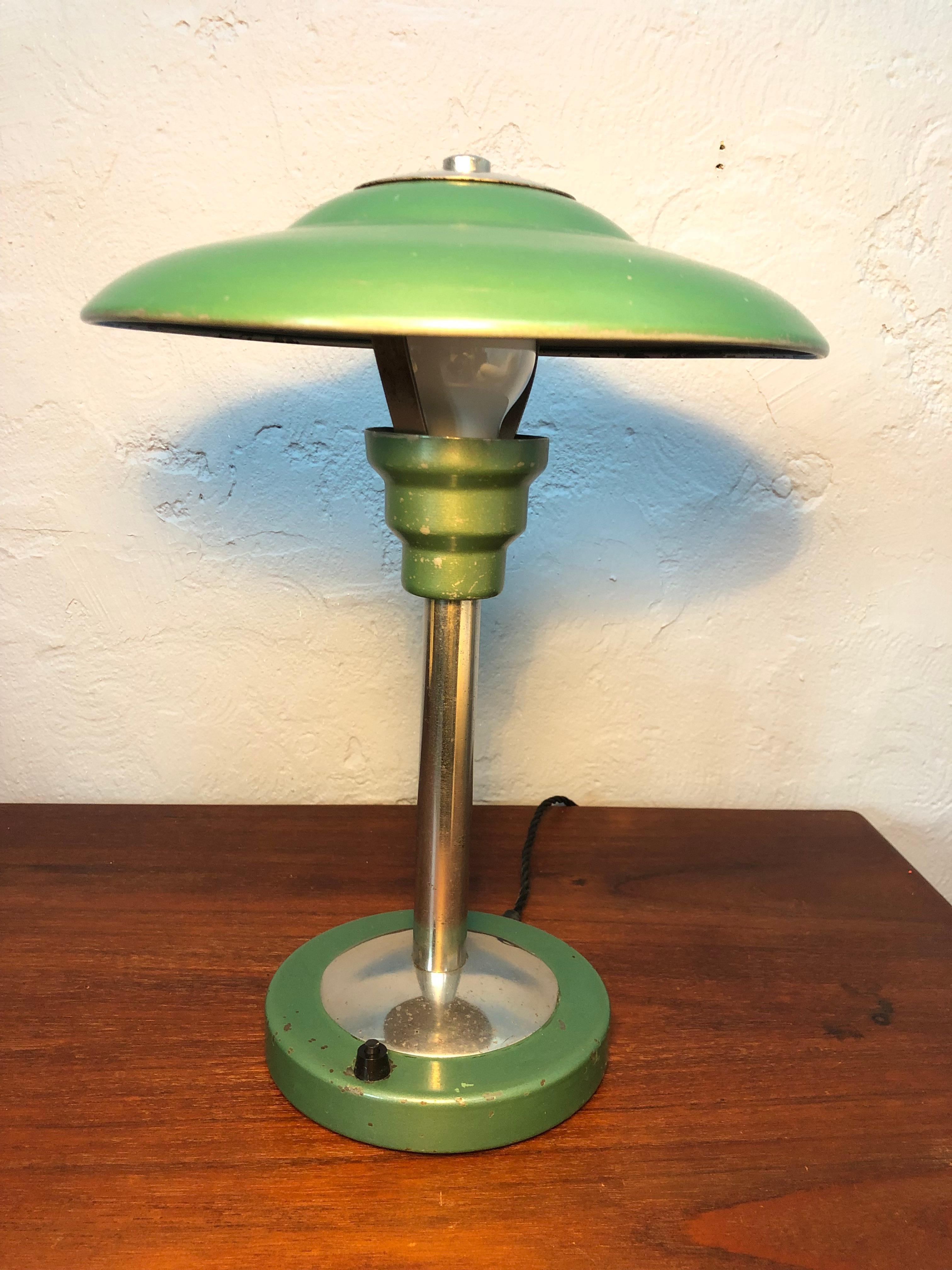 A Bauhaus table lamp in the manner of Max Schumacher of Germany. 
This classic Bauhaus lamp is in its original green paint with signs of wear from the around 70 years of use. 
The lamp has been dismantled cleaned and rewired with a black twisted