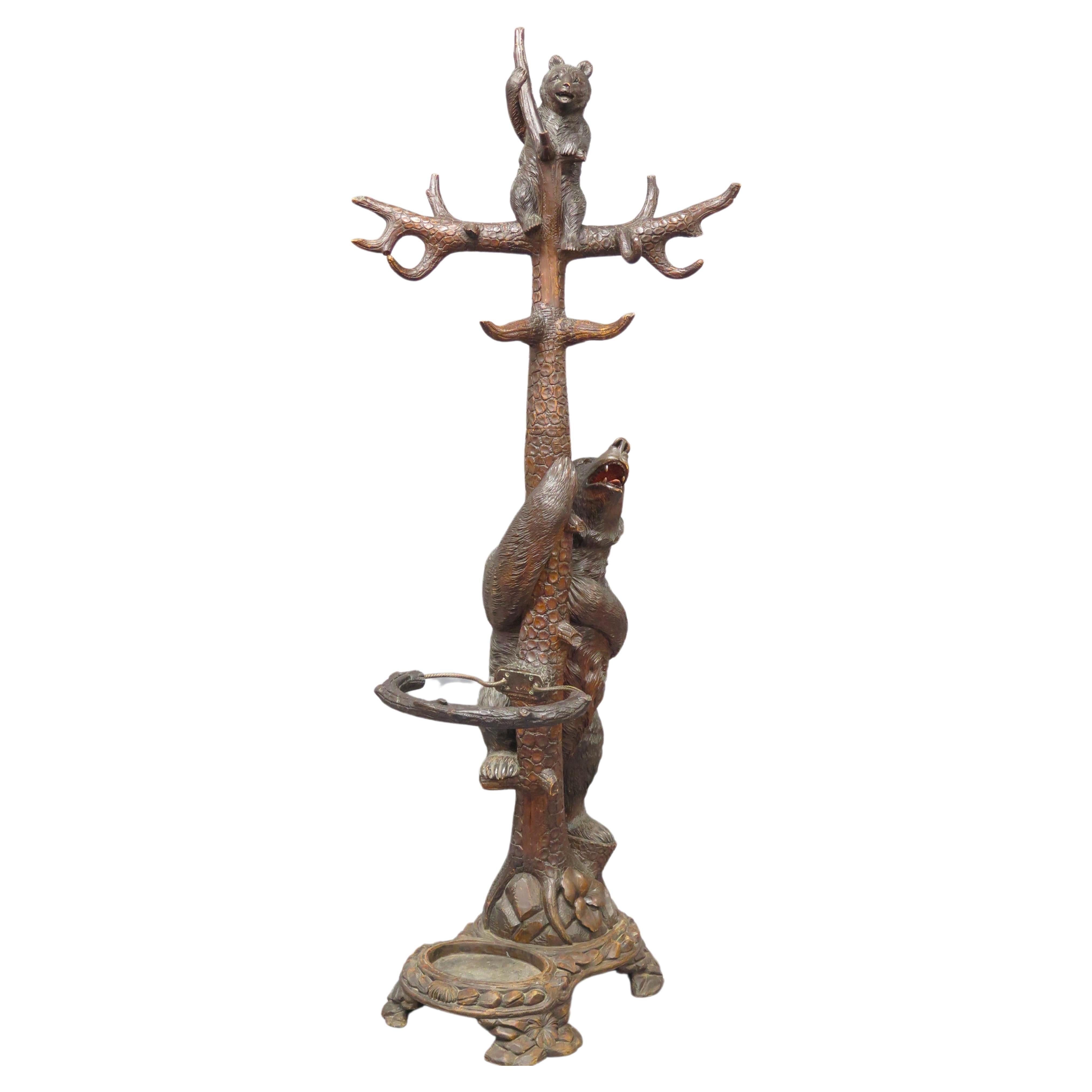 A beatifully 19th Century hand-carved Brienz  black forest hall stand with a mama bear and cub, this naturalistically carved hall stand depicts a standing moma bear next to a tree, with open mouth and eyes ( glass ) watching her cub in the branches