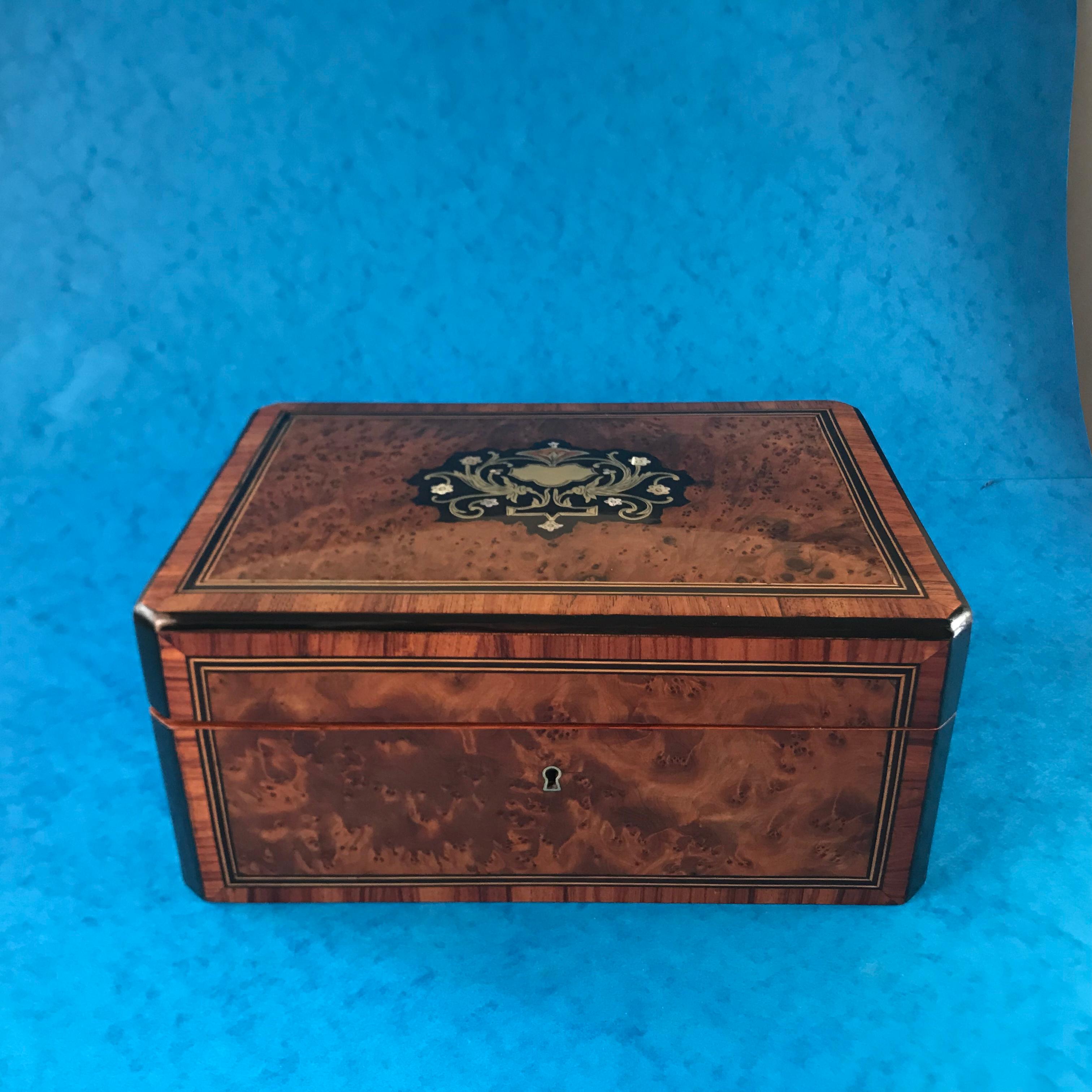 A beautiful 19th century 1870 French burr cedar box, inlaid with brass, mother of pearl and ebony and its Cross banded in tulip wood,it has a relined interior, unfortunately the key doesn’t work the lock, But it’s stunning box, it would make the