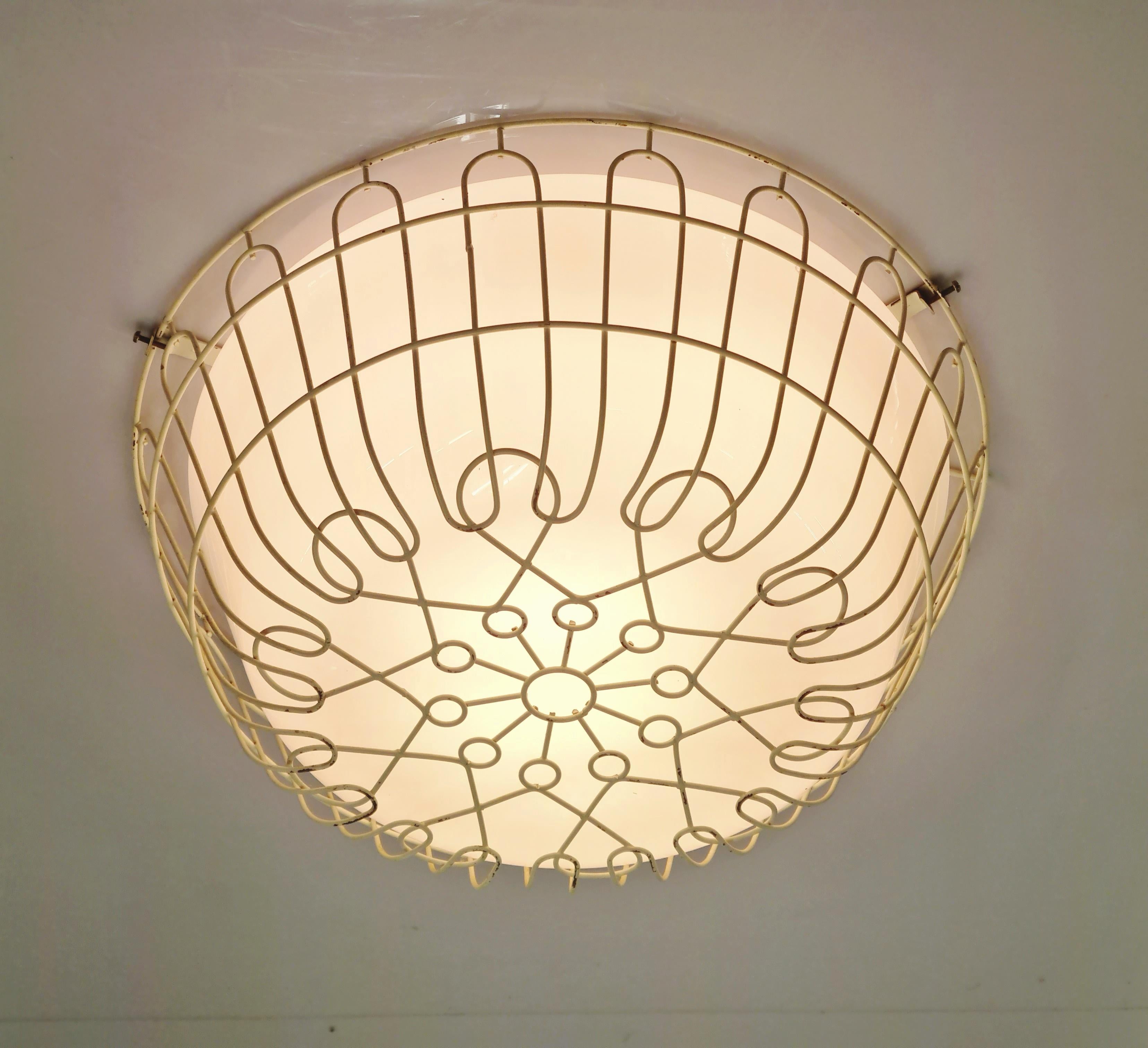 A rare and beautiful ceiling lamp by Finnish designer Lisa Johansson-Papé from the 1950s. An absolute gem harmoniously combining esthetics and functionality. This lamp design was originally intended for spaces with rough activities with the idea