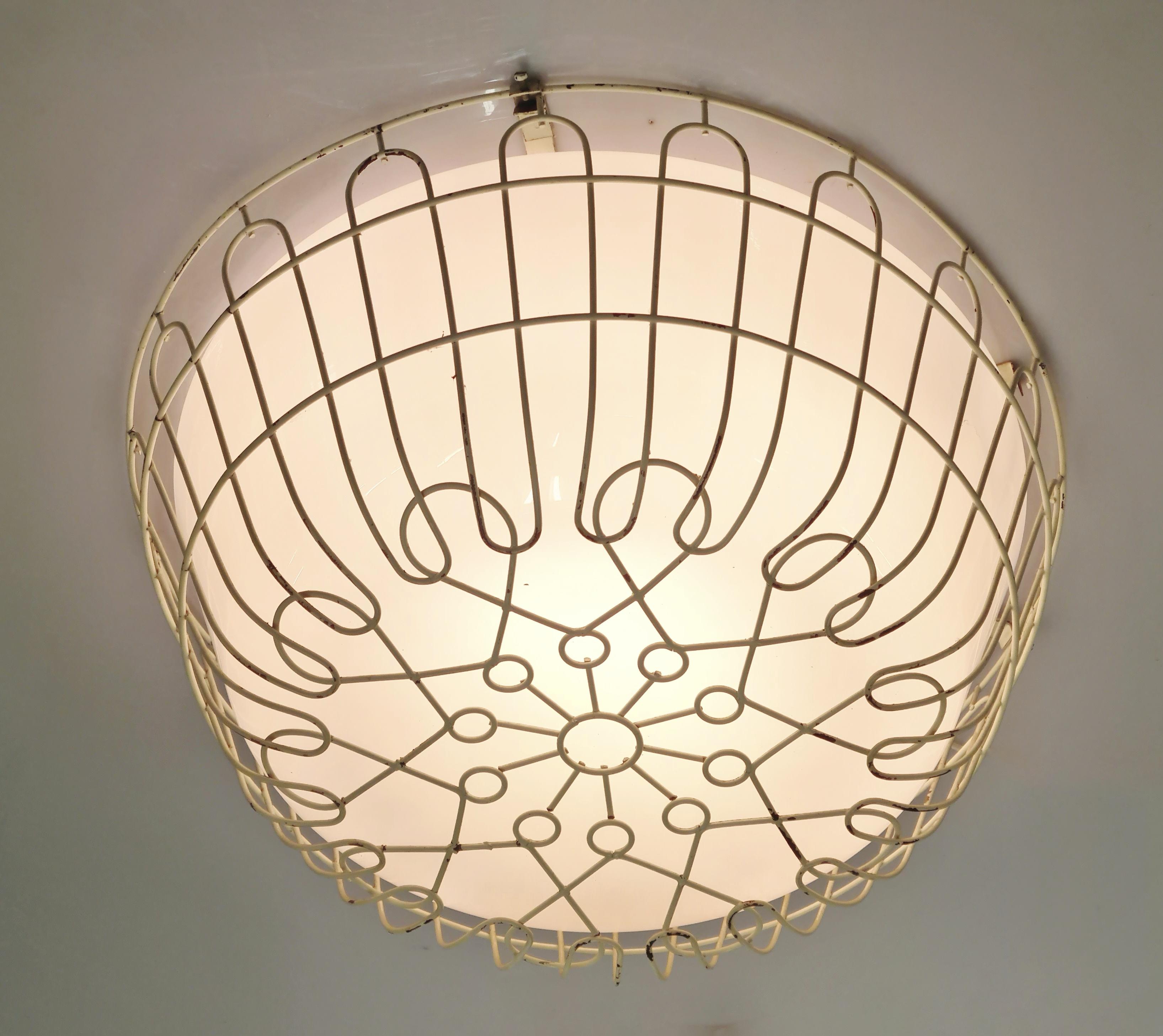 A rare and beautiful ceiling lamp by Finnish designer Lisa Johansson-Papé from the 1950s. An absolute gem harmoniously combining esthetics and functionality. This lamp design was originally intended for spaces with rough activities with the idea