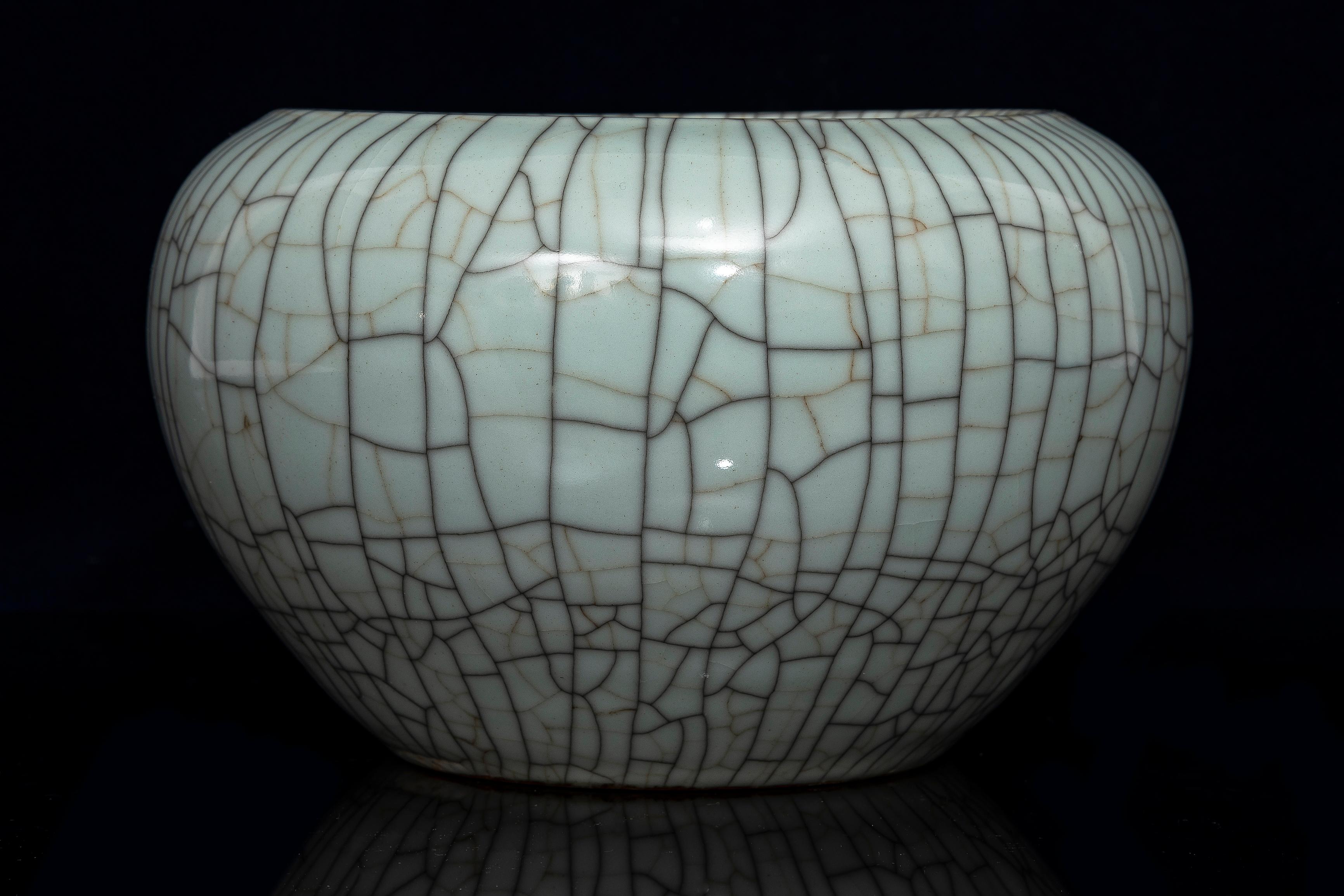 A Beautiful Chinese Celadon Crackle Ge Ware Bowl.  The bowl showcases the distinctive crackled glaze characteristic of Ge ware. The bowl features a pale greyish-ivory glaze with a network of black and golden-brown crackles, often referred to as
