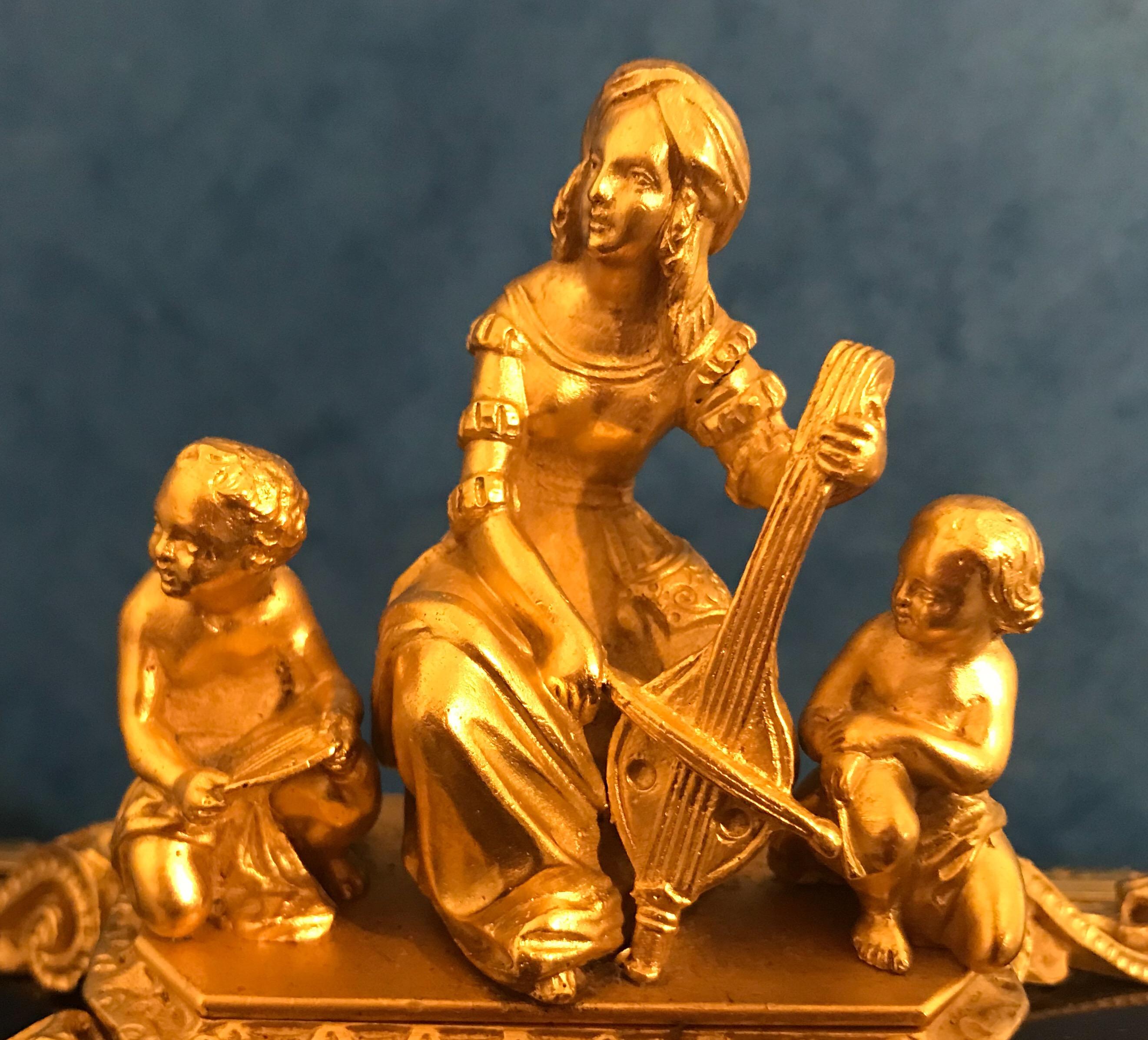 This is a beautiful decorative French 1830 ebony and Ormolu sarcophagus box. It has a drawer to the front, a working lock and key and velvet lined to the interior. It has a lady playing a violin with two children at the top of the box, it really is