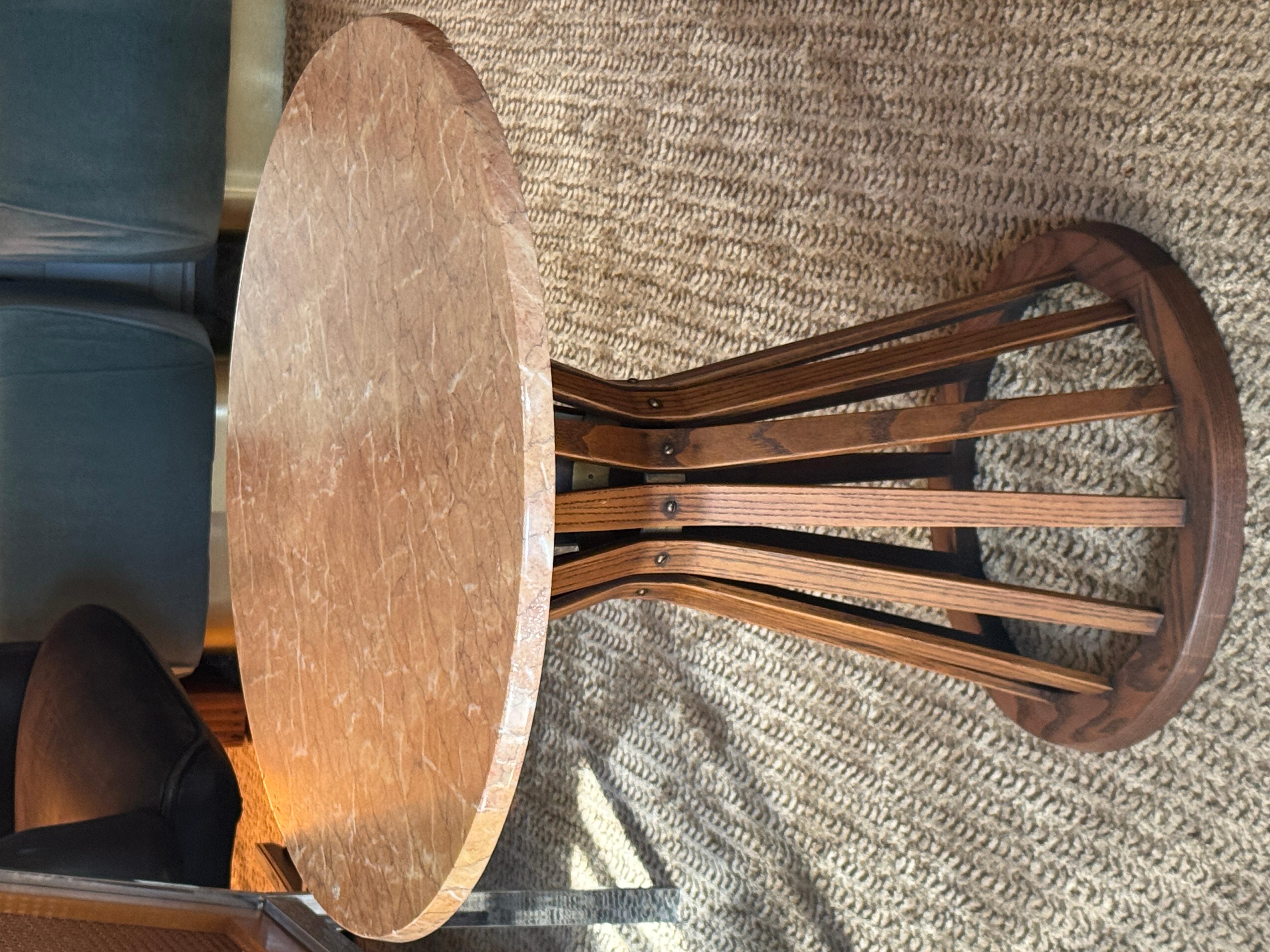 A beautiful Edward Wormley for Dunbar famous sheaf of wheat accent table, circa 1960s. Notable mid century design featuring an hourglass oak frame supporting a round pink marble top. Base is in excellent condition for its age and marble top is not