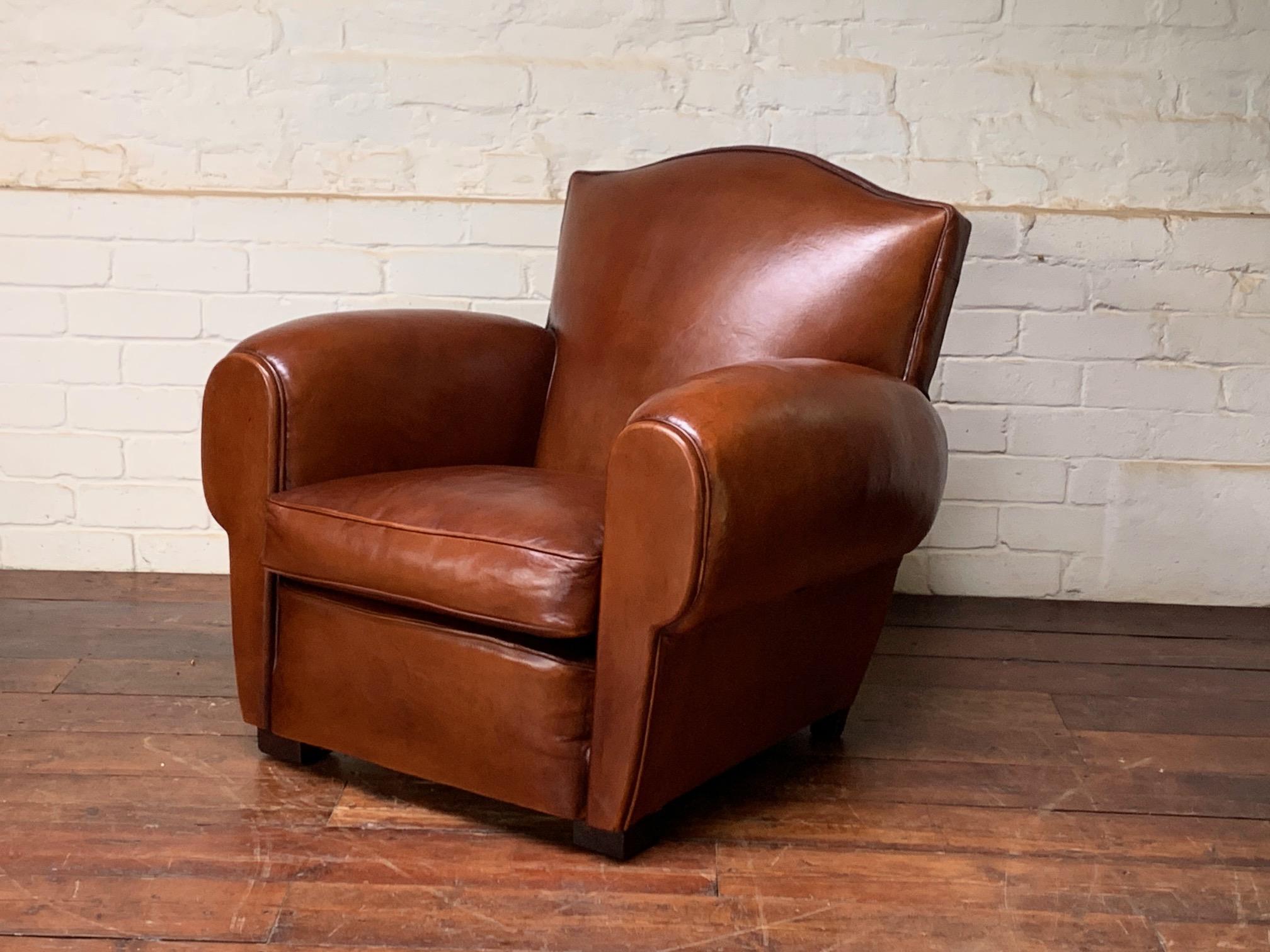 This is a gorgeous chair, in wonderful condition. Through time and wear this chair boasts the most beautiful patina, of which the hues change according to different lighting conditions: from warm chestnut to rich Havana brown; it is really, very