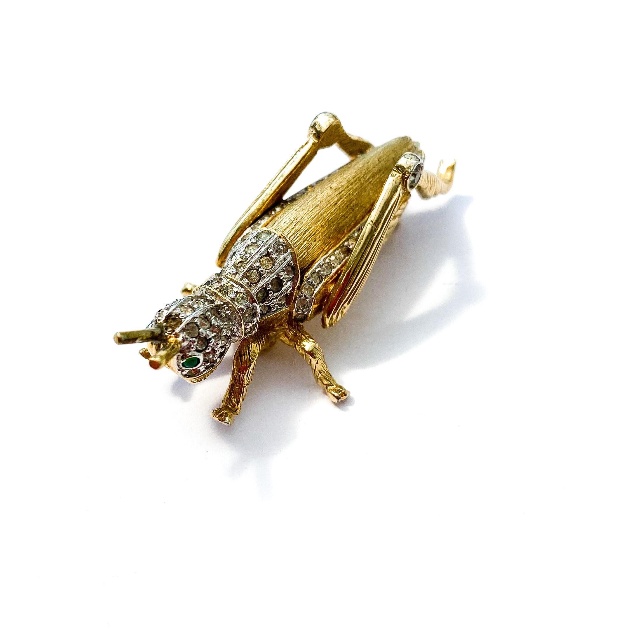 An exquisitely modelled three dimensional brooch in the form of a grasshopper, from mid century American fashion designer , Nettie Rosenstein. Of outstanding quality, this brooch depicts this insect beautifully, charming to look and and to wear. Pin