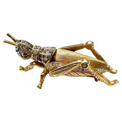 A beautiful gilt and clear paste 'grasshopper' brooch, Nettie Rosenstein, 1960s.
