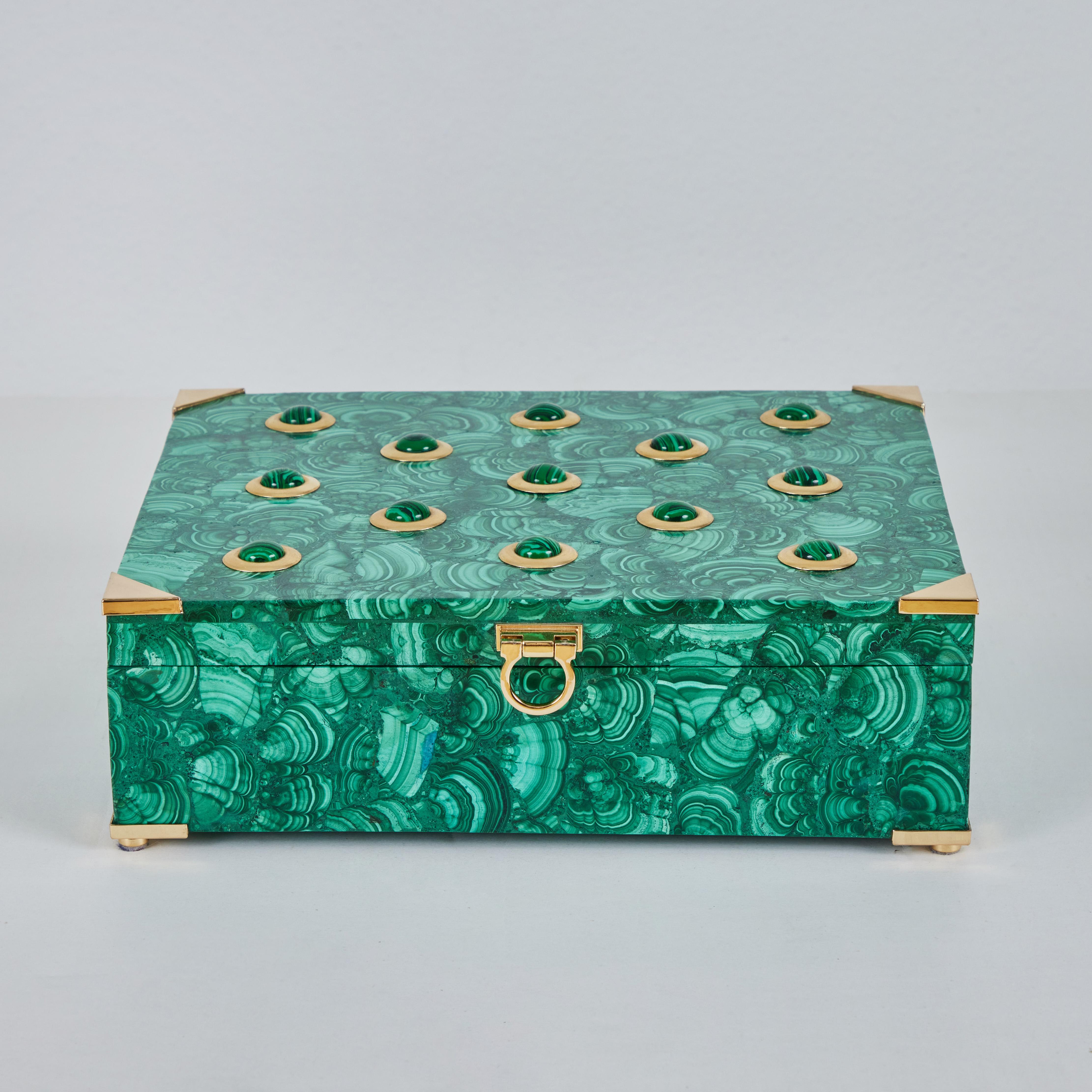 This is an impressive 14lbs malachite box with brass fittings and hardware.  This box showcases multiple shades of green, from light to dark.  What stands out about this piece is its size at 14lbs, and the beautiful swirls and patterns adorning the