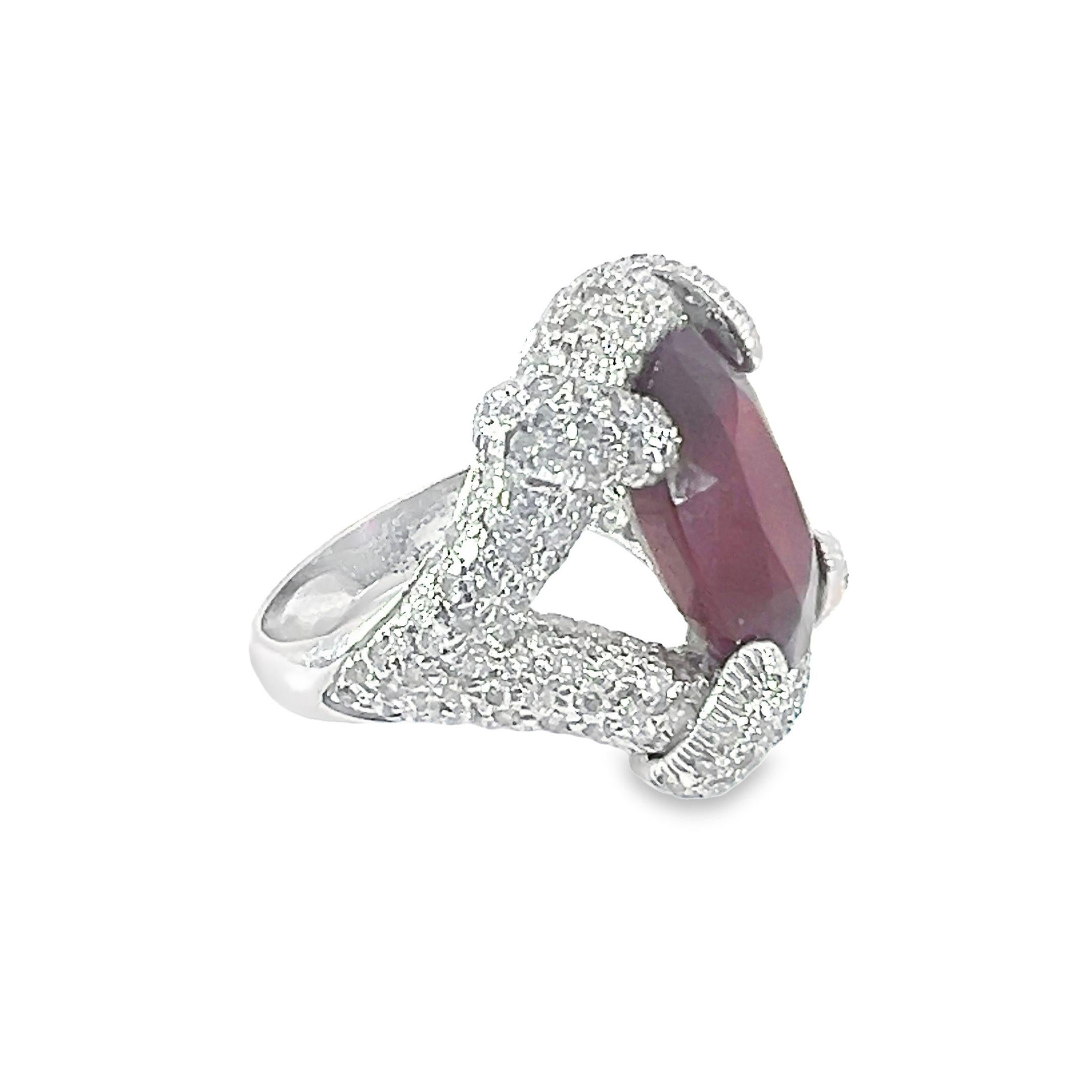 A beautiful natural 10.70-carat oval shaped Glass filled ruby with 2.50-carat diamond ring set in 18-Kt white gold.
This ring has a magnificent ruby at its center, which is delicately framed by a sophisticated arrangement of brilliant diamonds,