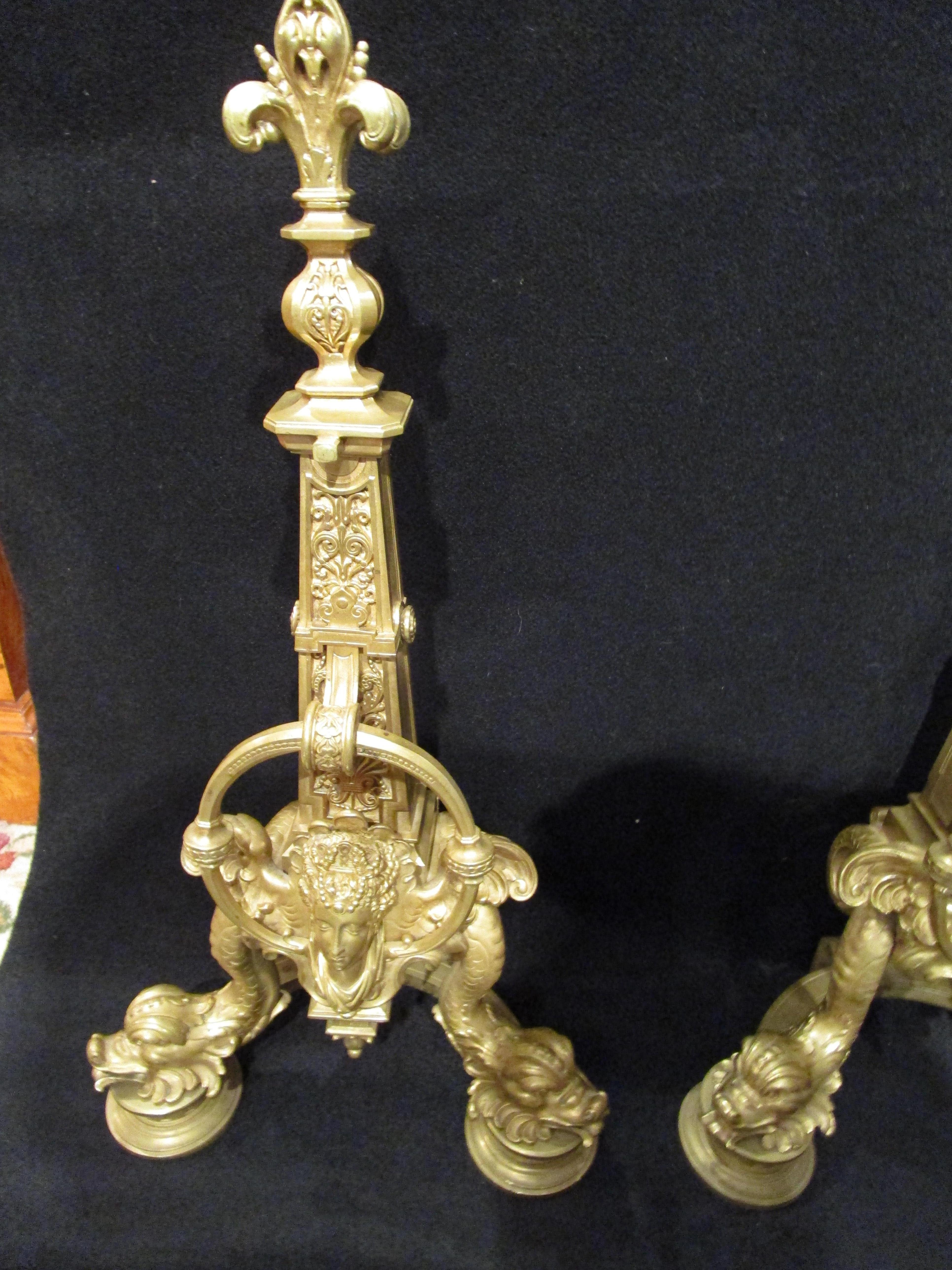 A fine pair of 19th century French Empire style gilt bronze chenets with dolphin feet.