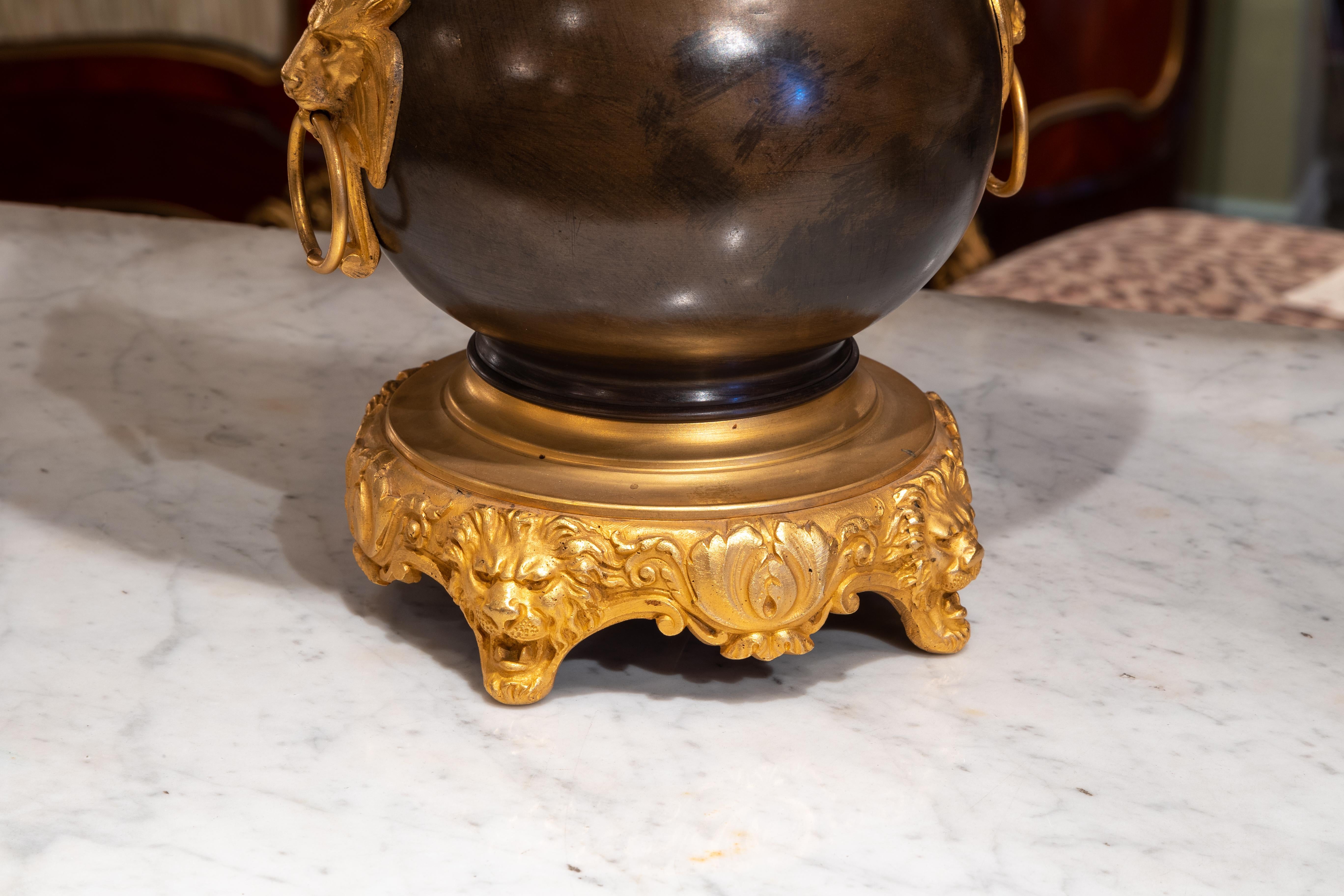 A fine pair of 19th century French Rgence style bronze and gilt bronze mounted oil lamps converted for electricity.

Fine quality gilt bronze lions heads mounts.