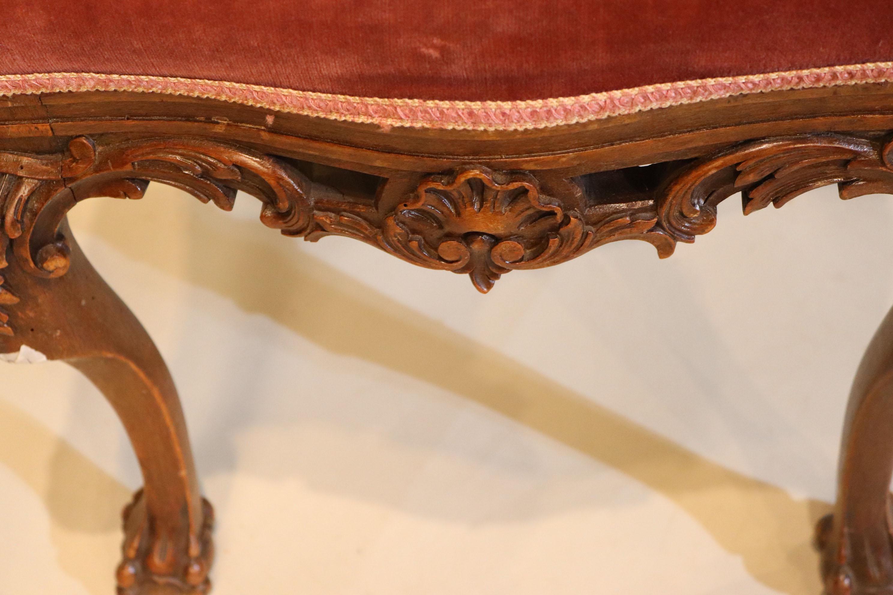 A fine pair of 19th century Portuguese mahogany hand carved benches. Elaborately carved and detailed with pawed feet