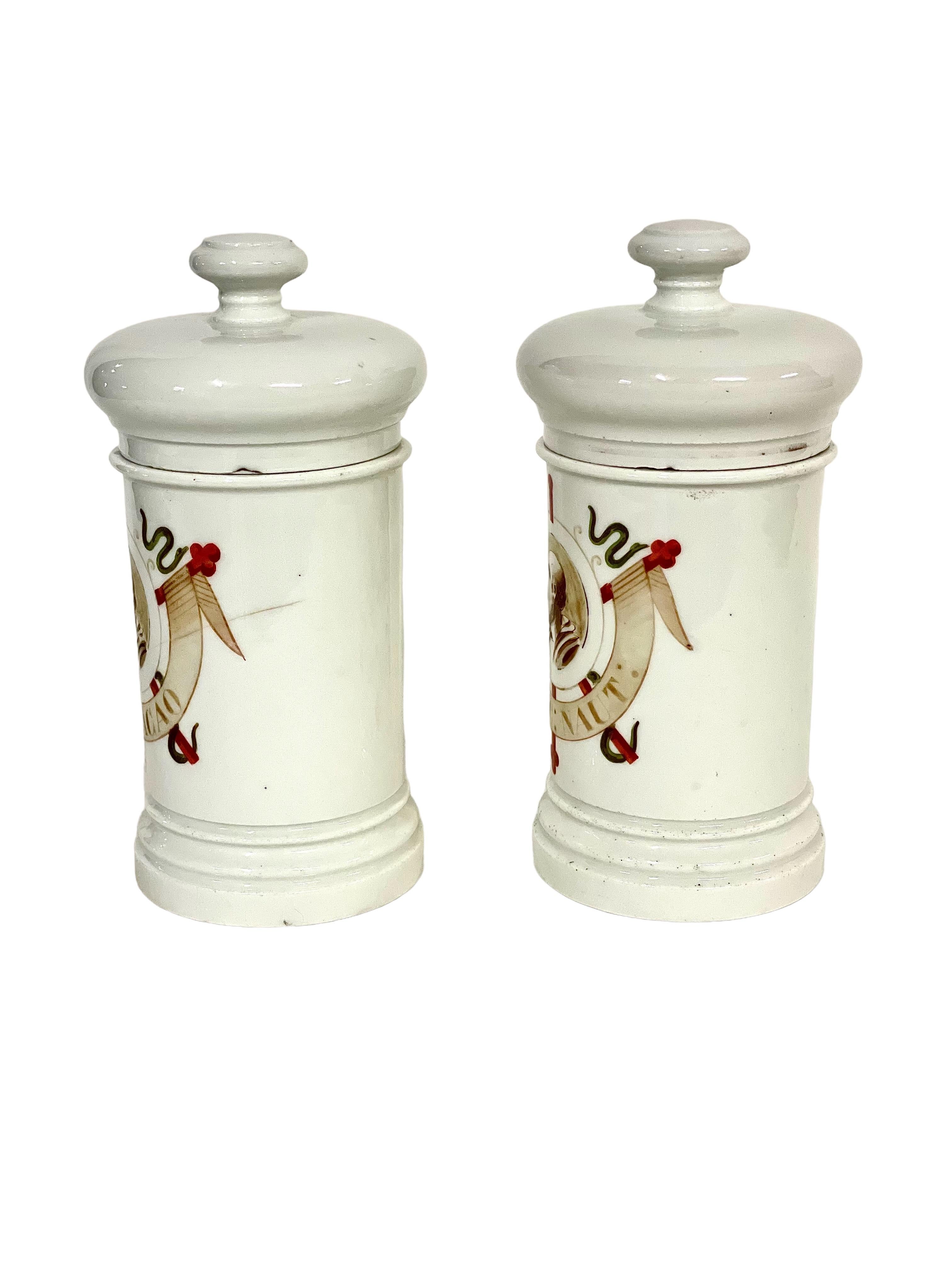 A beautiful pair of antique 19th-century French porcelain lidded apothecary or pharmacy jars, with elegant hand-painted decoration and lettering, and maker's mark on the base. A depiction of the ancient Greek physician Hippocrates is emblazoned on