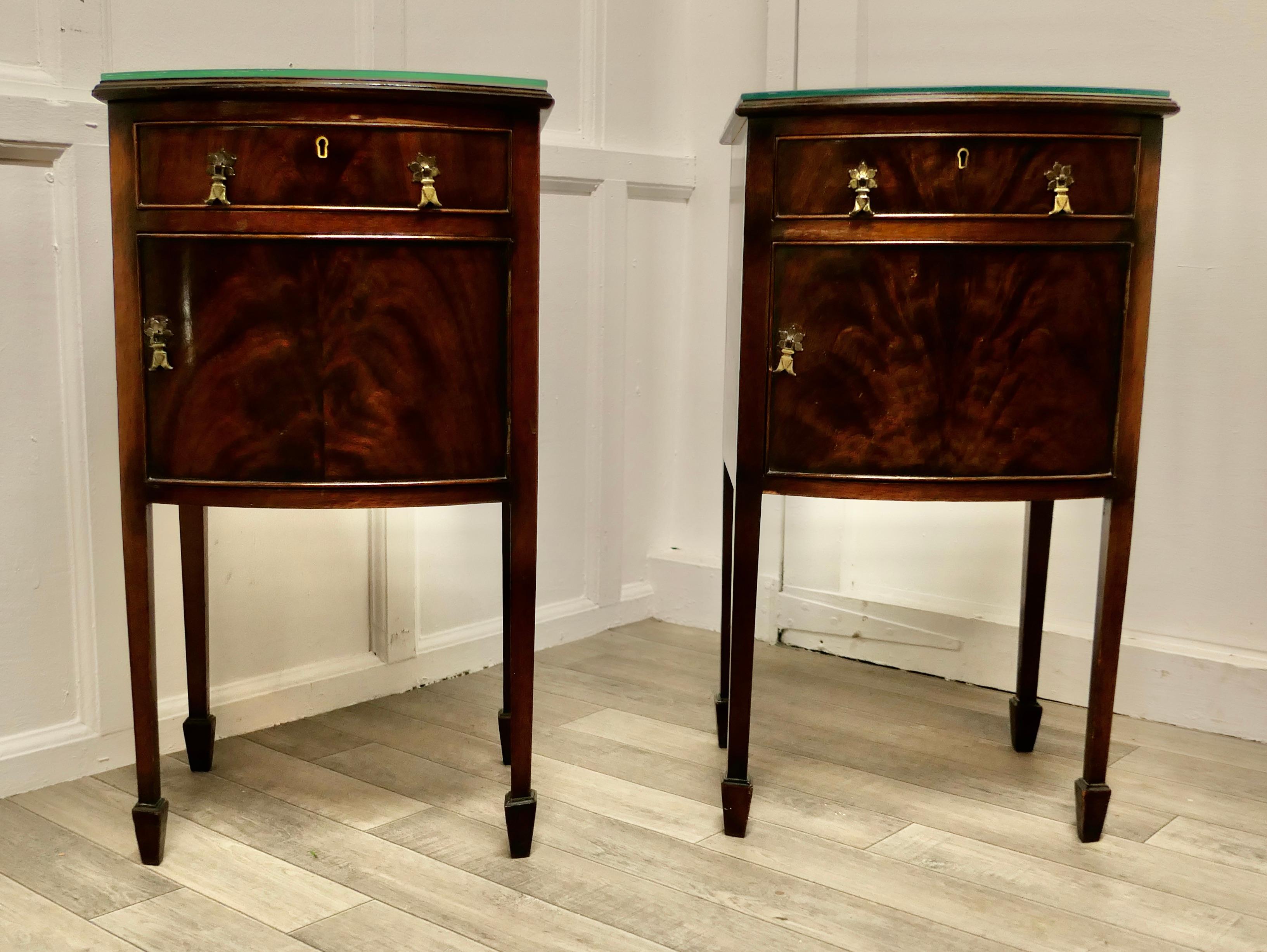 A beautiful pair of flame mahogany bedside cupboards.

This is a lovely pair of bedside cabinets, the tops have a moulded edge and both the tops and the fronts are in superb mirror veneer flame mahogany. 
The cabinets have a drawer and stand on