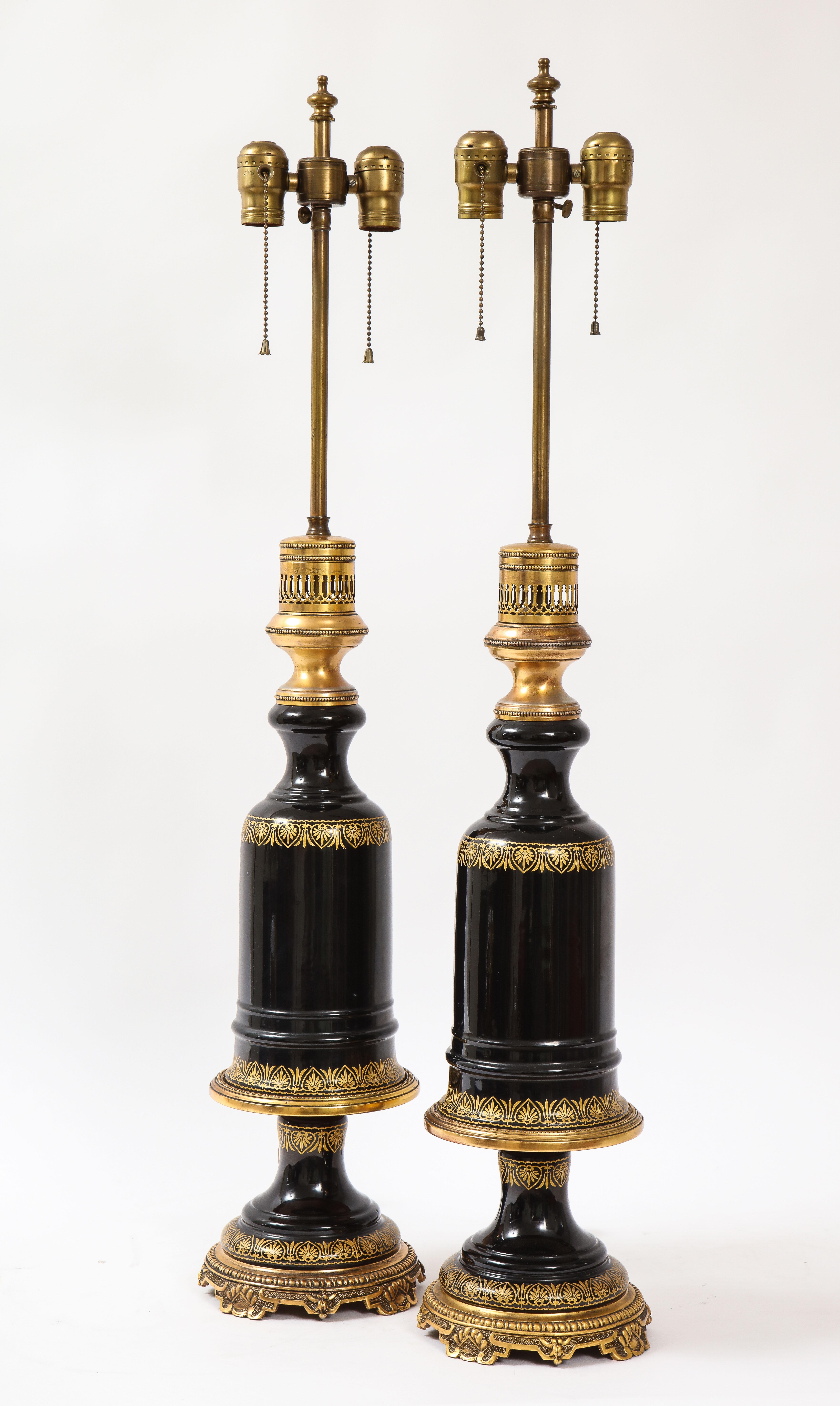 A beautiful pair of French gilt bronze mounted black amethyst crystal lamps. Each is beautifully hand blown out of black amethyst crystal and further adorned with 24-karat gilt decoration. They are each skillfully mounted on gilt bronze mounts which
