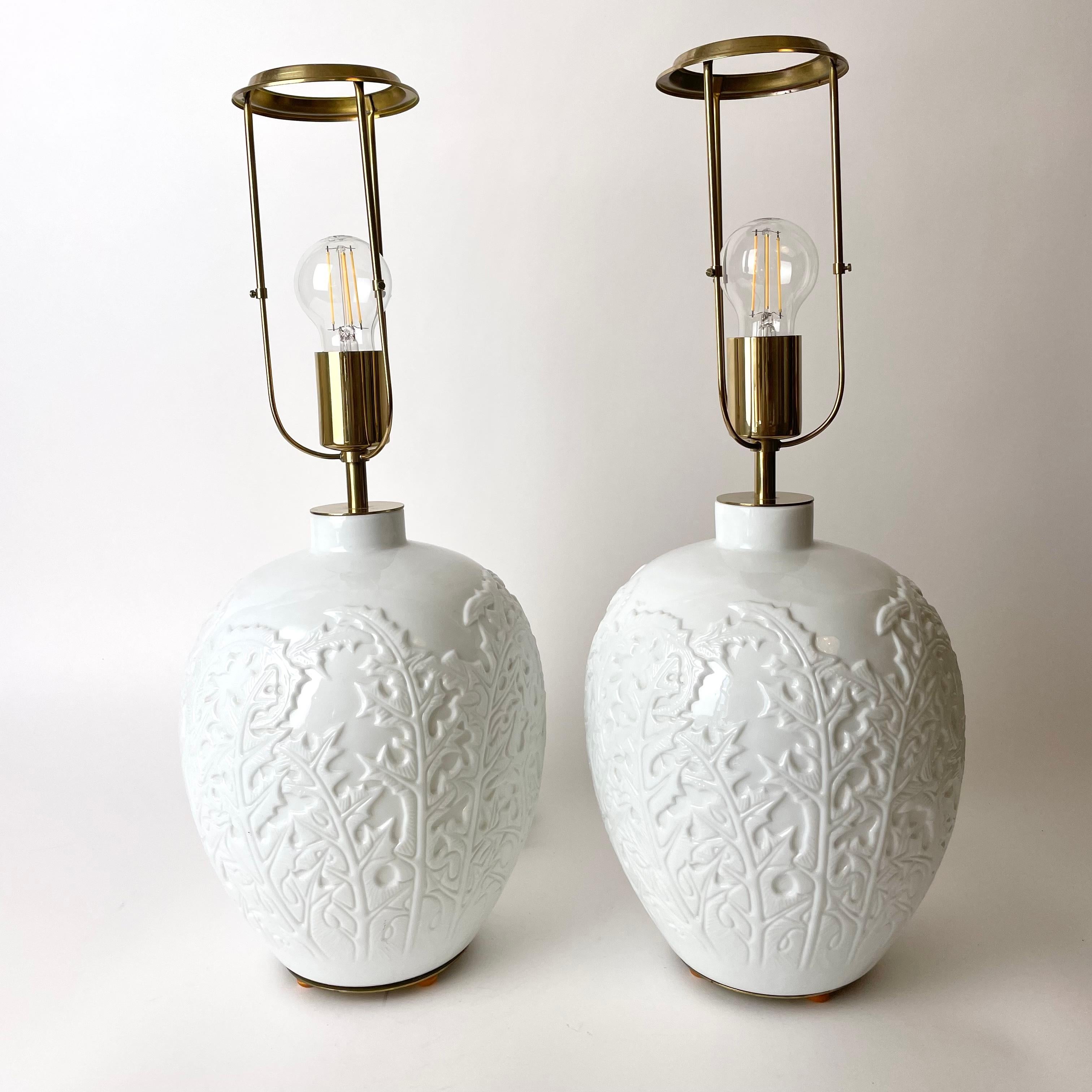 A beautiful and big pair of Table Lamps from Firma Svenskt Tenn, Sweden in opaline white glass with details i brass. Mid-20th Century. Elegantly decorated with thistles. Very unusual model.

Newly drawn electricity.

Wear consistent with age and