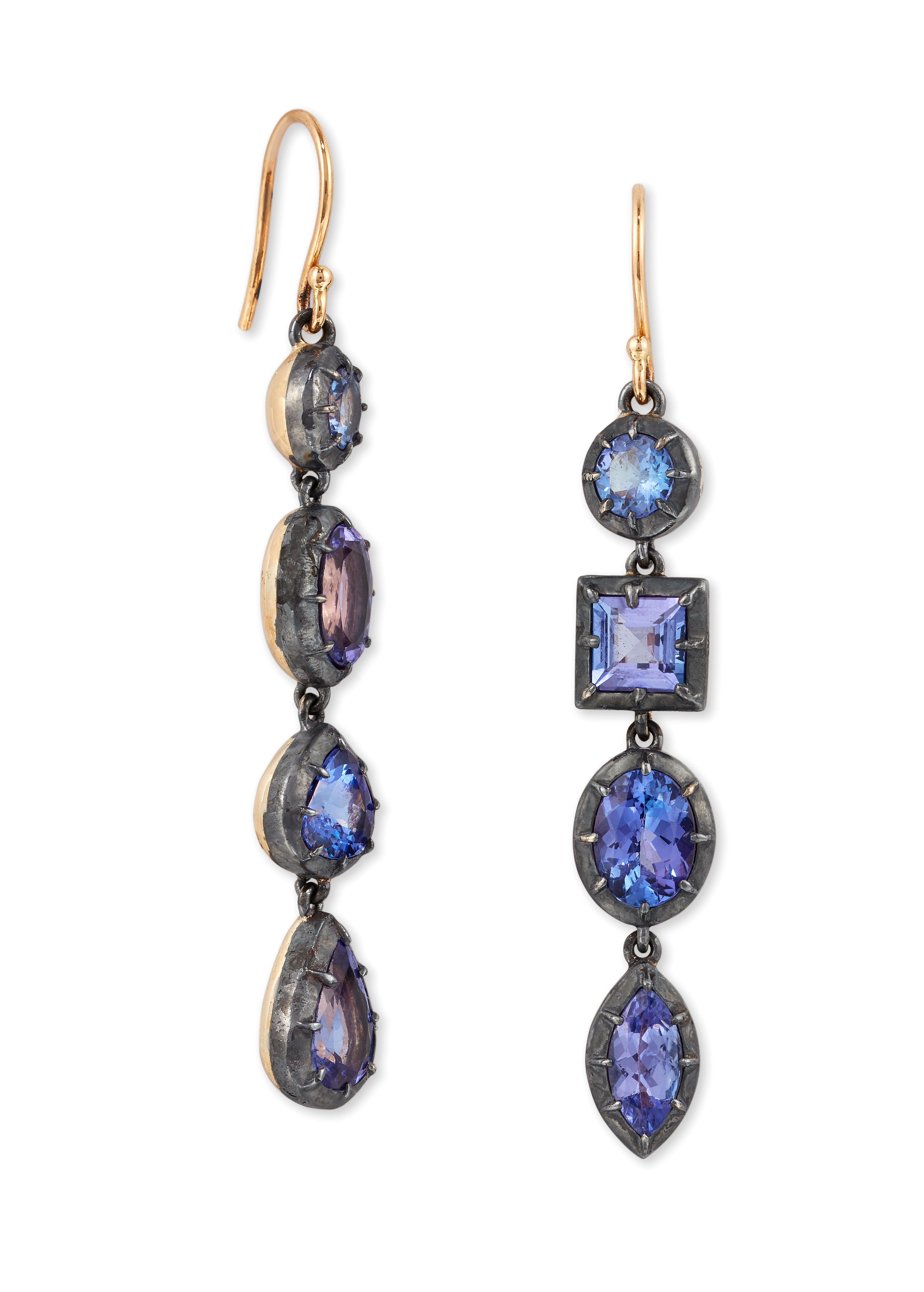 A Pair of Tanzanite Earrings, set with multi-Shapes.

Composed of a Line of collet set Oval, Square, Marquise and pear shape Tanzanite's, with hook fittings set in 18ct Yellow gold and Silver. 