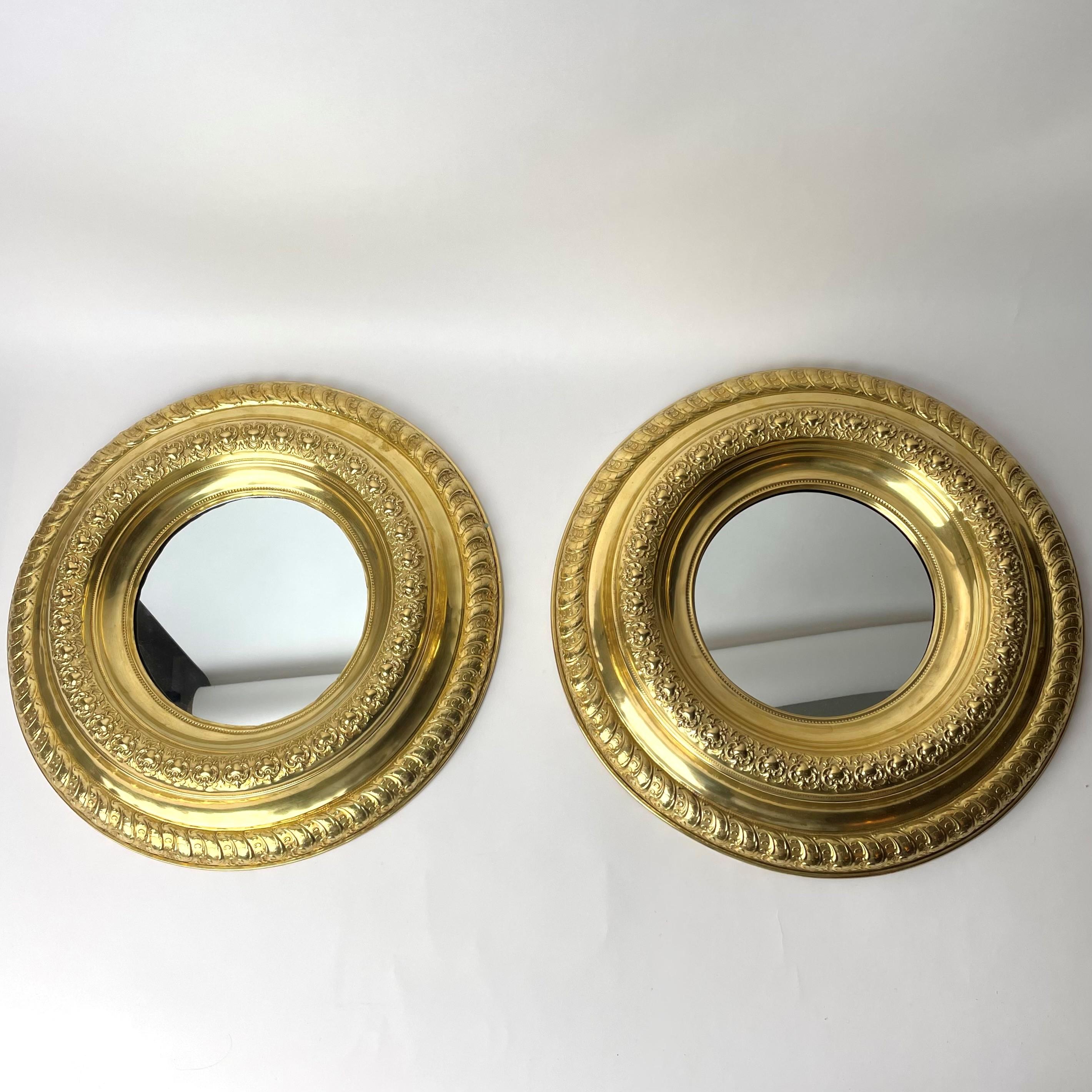 A pair of fancy Wall Mirrors made of brass, from late 19th century. Beautifully decorated brass detailing, depicting floral and geometrical patterning in repoussé and chasing.

Wear consistent with age and use.
