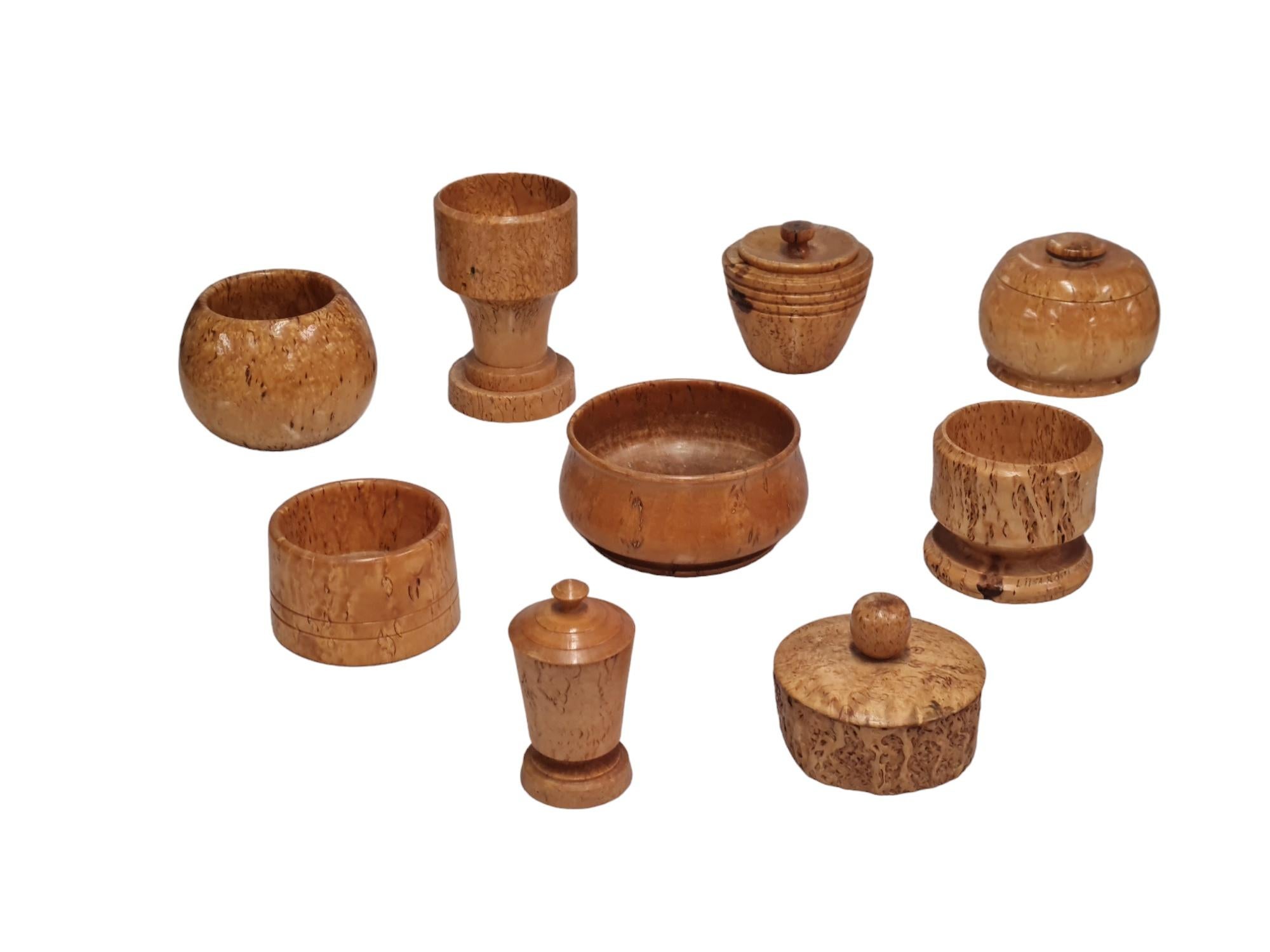A beautiful set of 9 unique curly birch bowls/objects, also known as silver birch boxes and bowls. Curly birch is a rare variety of birch that occurs naturally in Finland and is highly appreciated for its beautiful patterns in the wood, and is