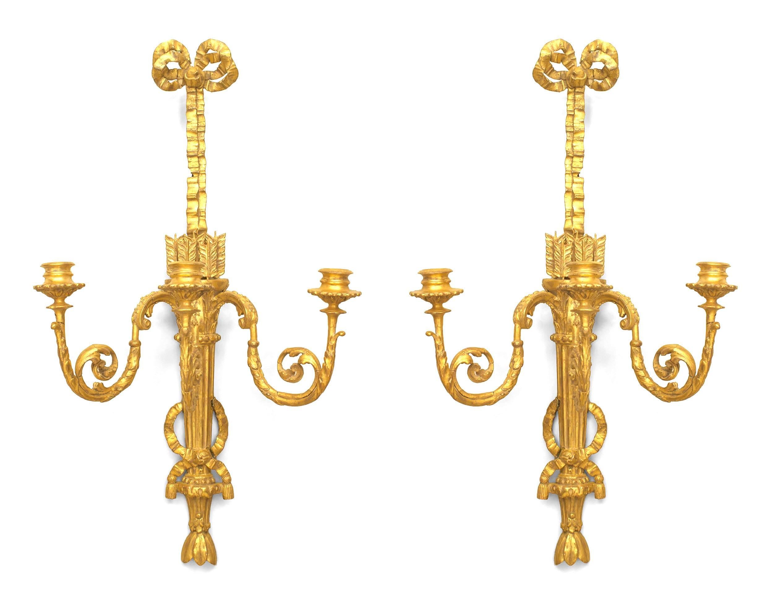 Pair of French Louis XVI (circa 1785) gilt wood three scroll arm wall sconces with a bow knot top and a design with arrows in a quiver. (PRICED AS Pair)
