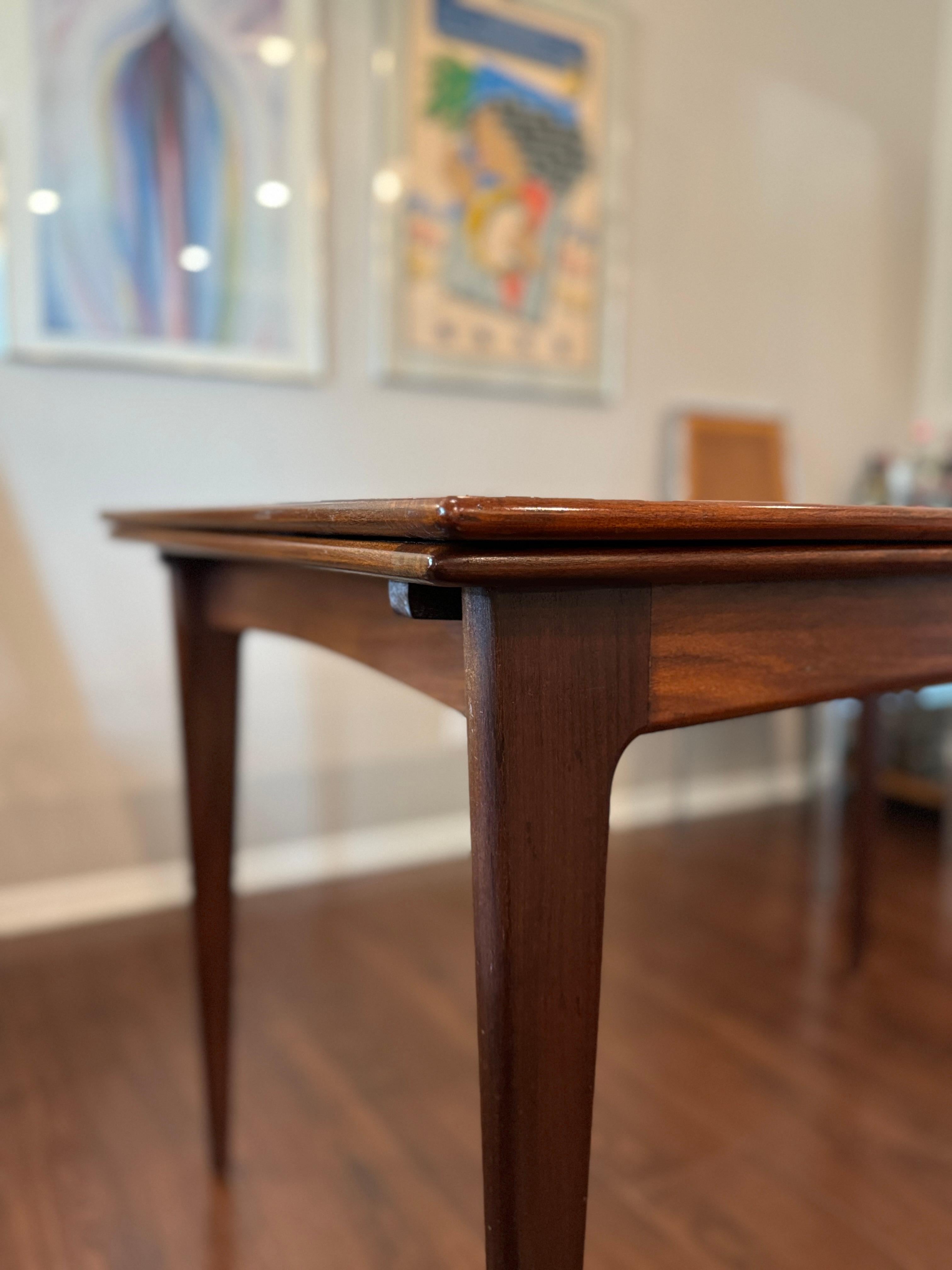 A beautifully designed extending draw leaf dining table designed by John Herbert 2