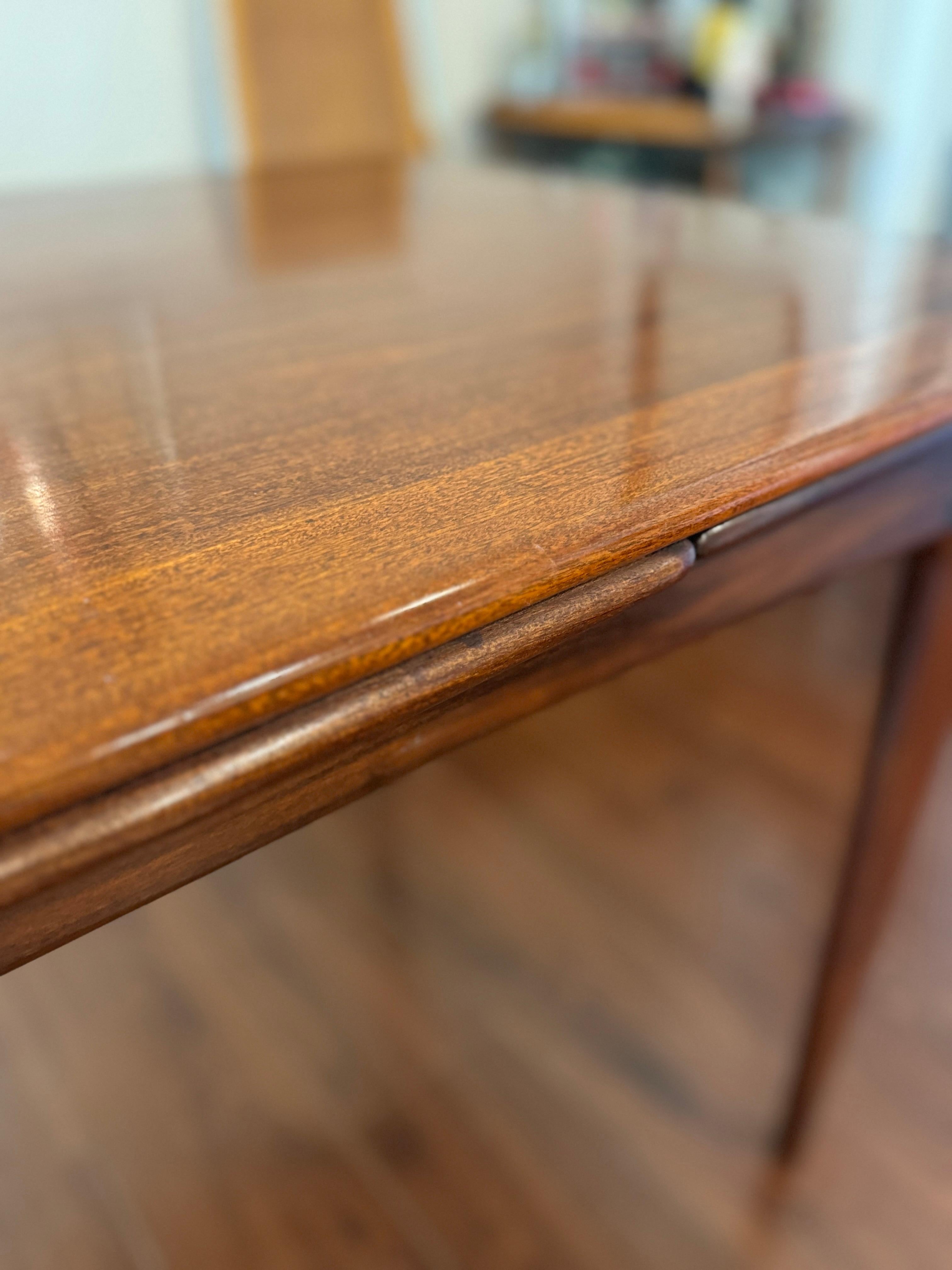 A beautifully designed extending draw leaf dining table designed by John Herbert 4