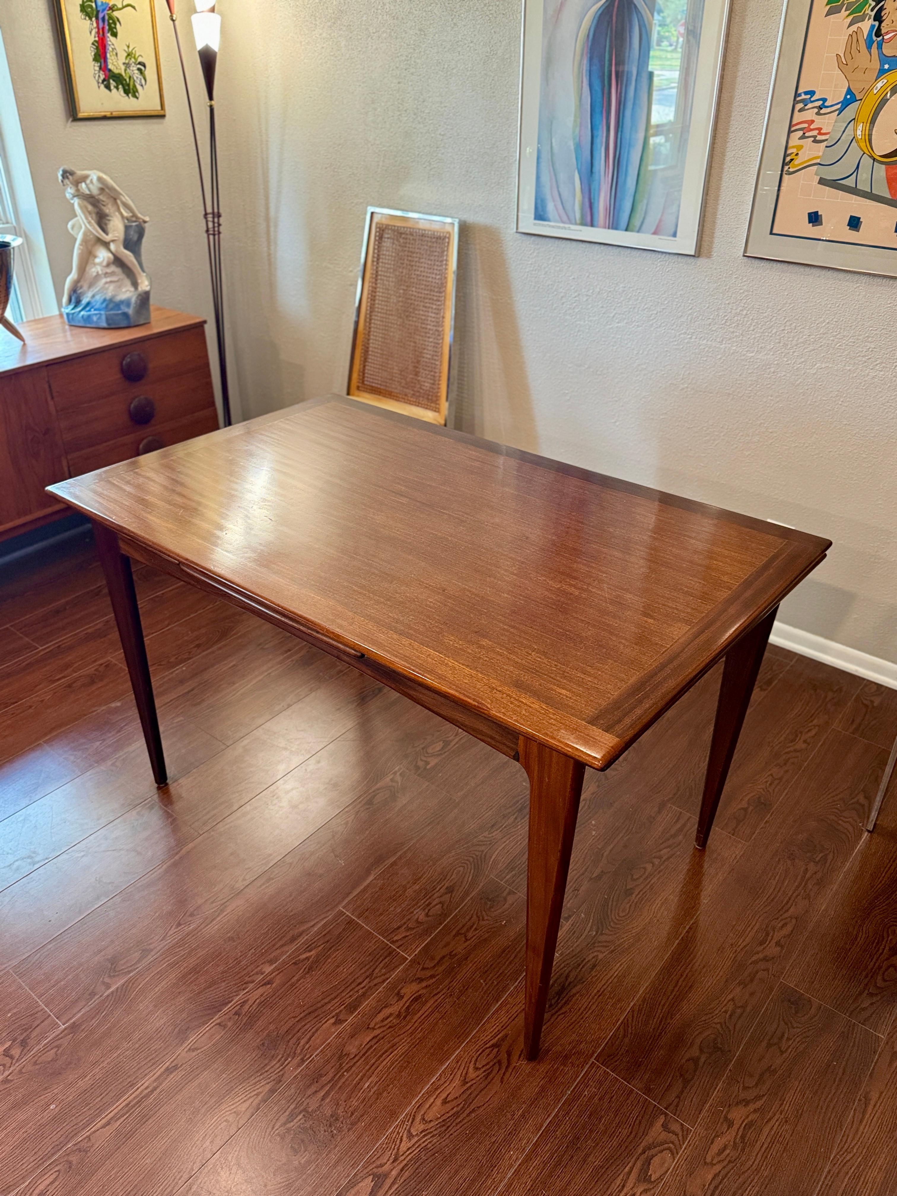A beautifully designed extending draw leaf dining table designed by John Herbert 7
