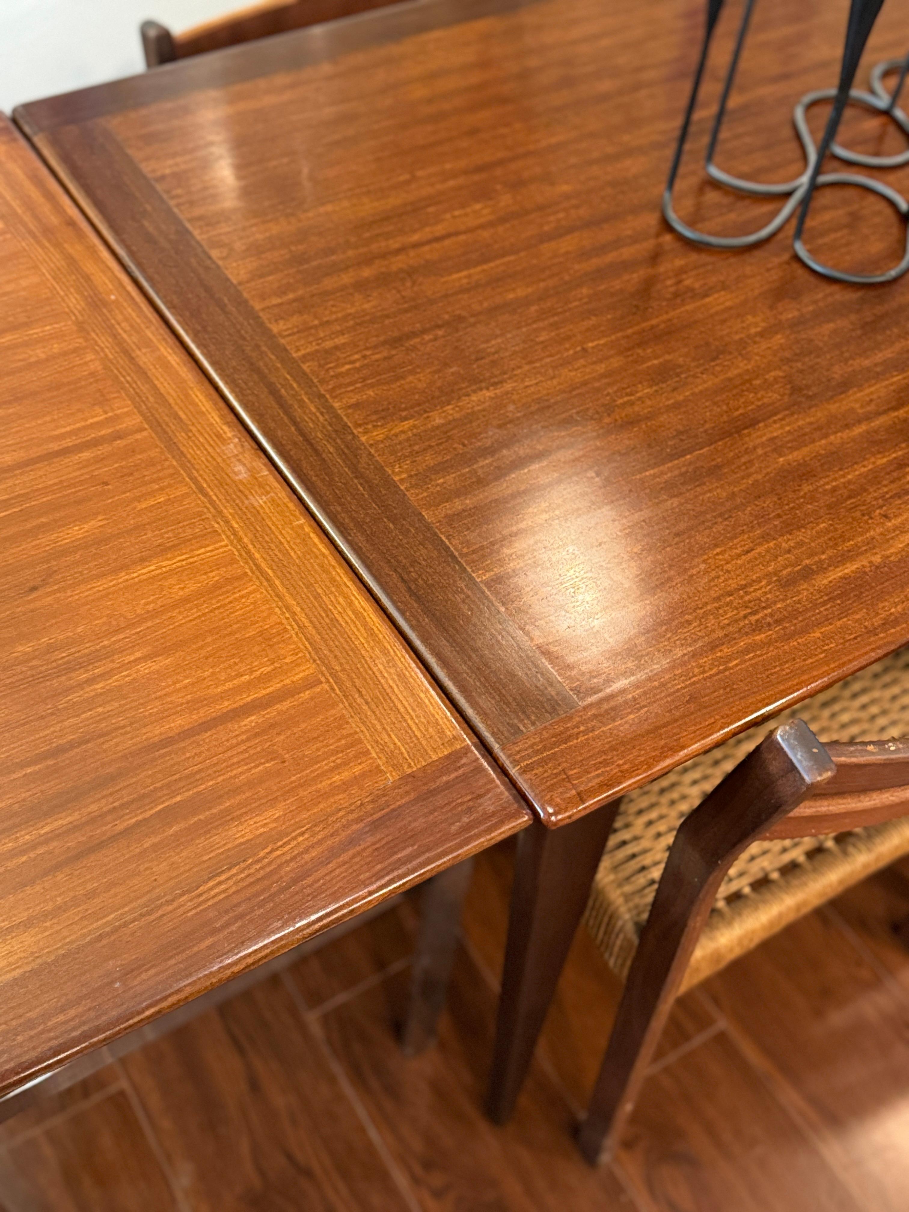 Unknown A beautifully designed extending draw leaf dining table designed by John Herbert