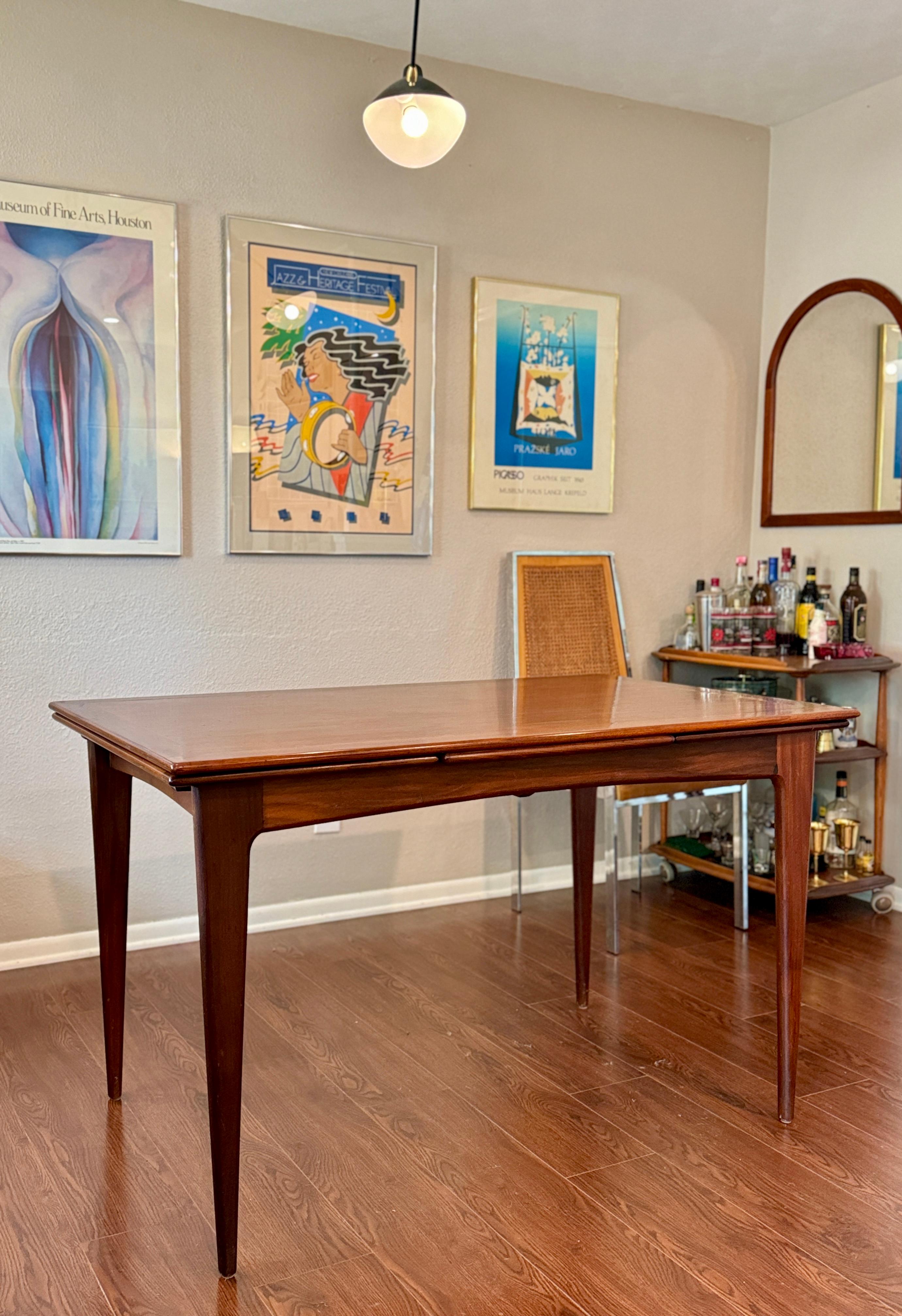 Mid-20th Century A beautifully designed extending draw leaf dining table designed by John Herbert