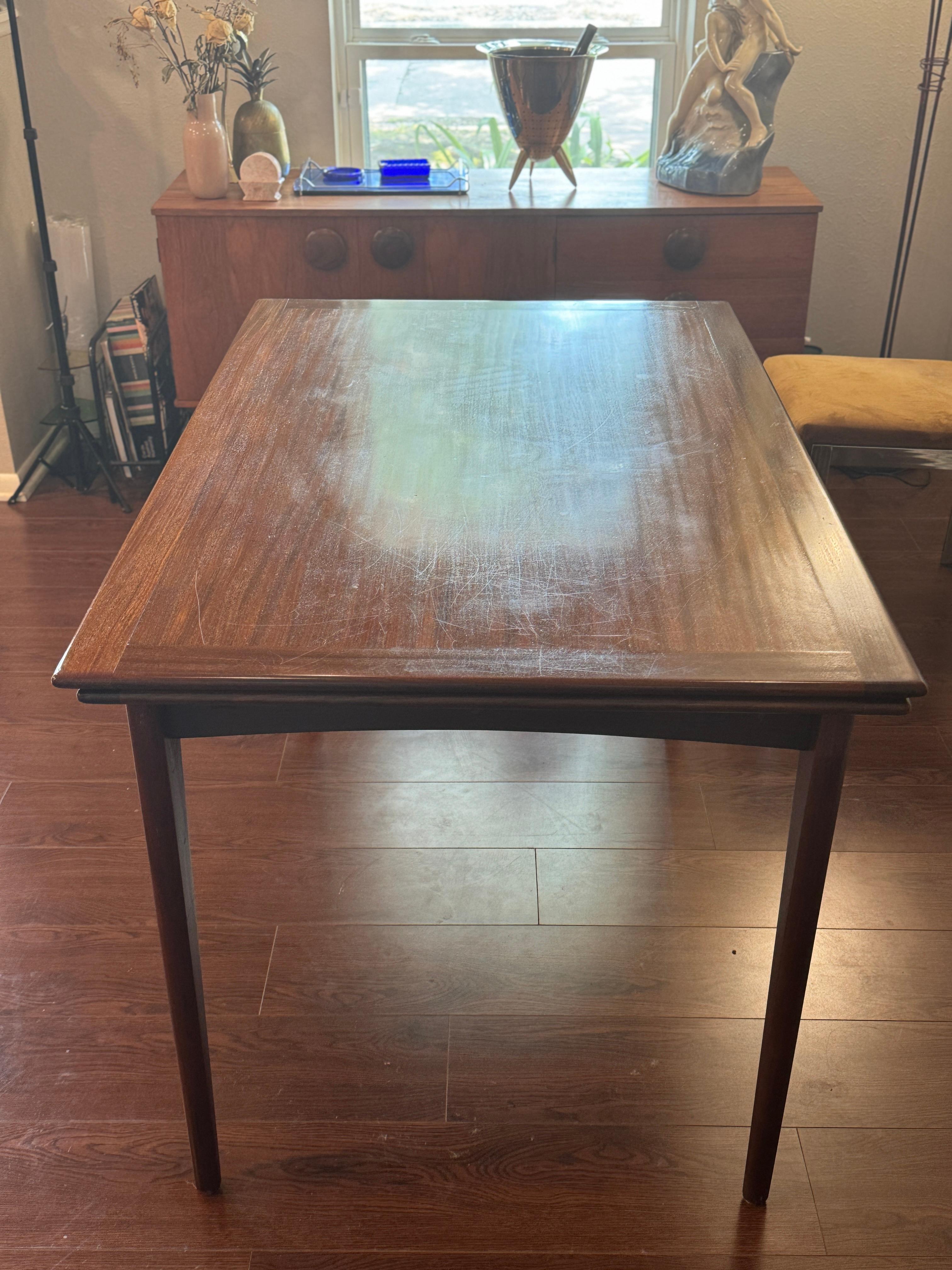 Teak A beautifully designed extending draw leaf dining table designed by John Herbert
