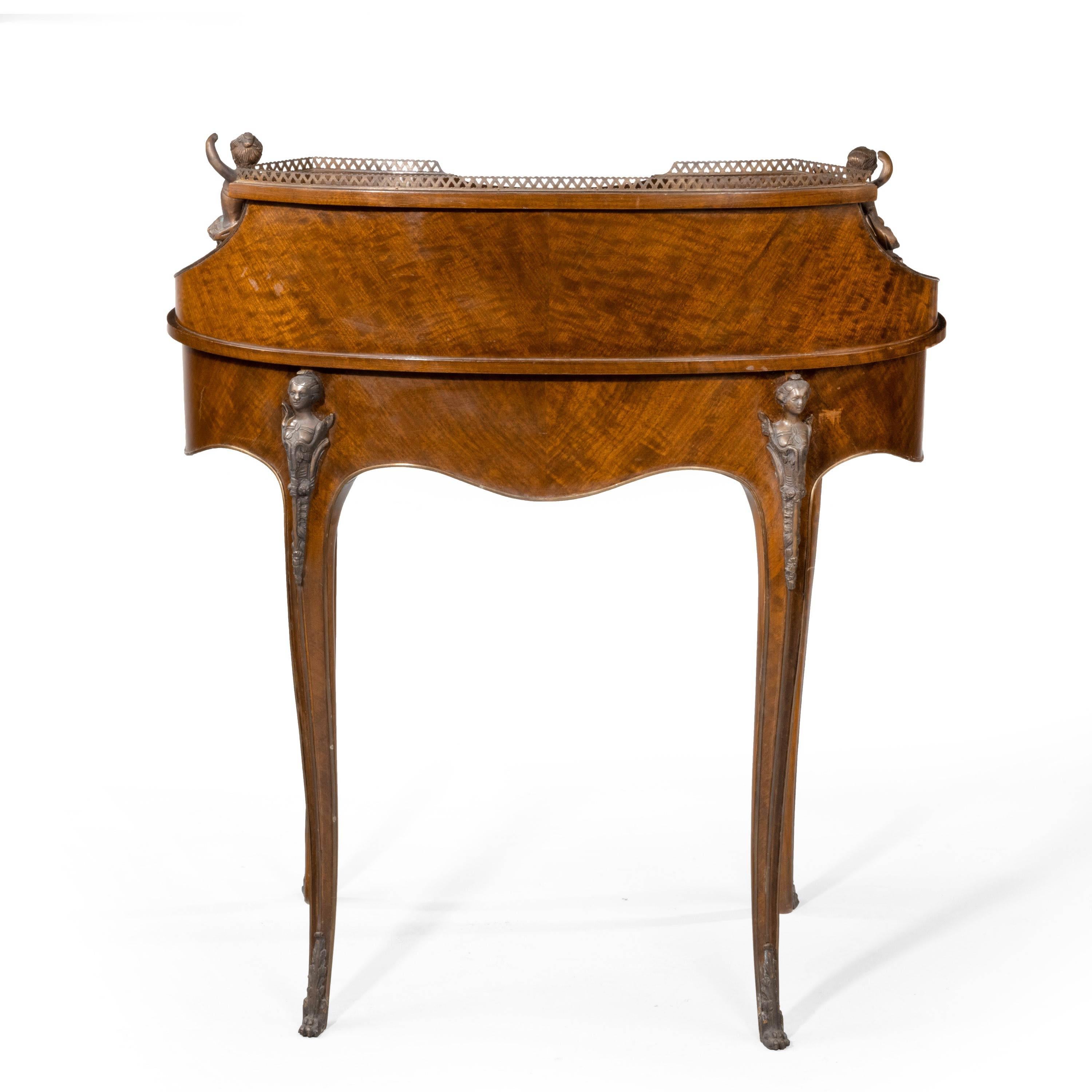 A beautifully figured and constructed French Bureau de Dame. Every side and piece of complex shape. With beautiful cast bronze Putti and decorations.