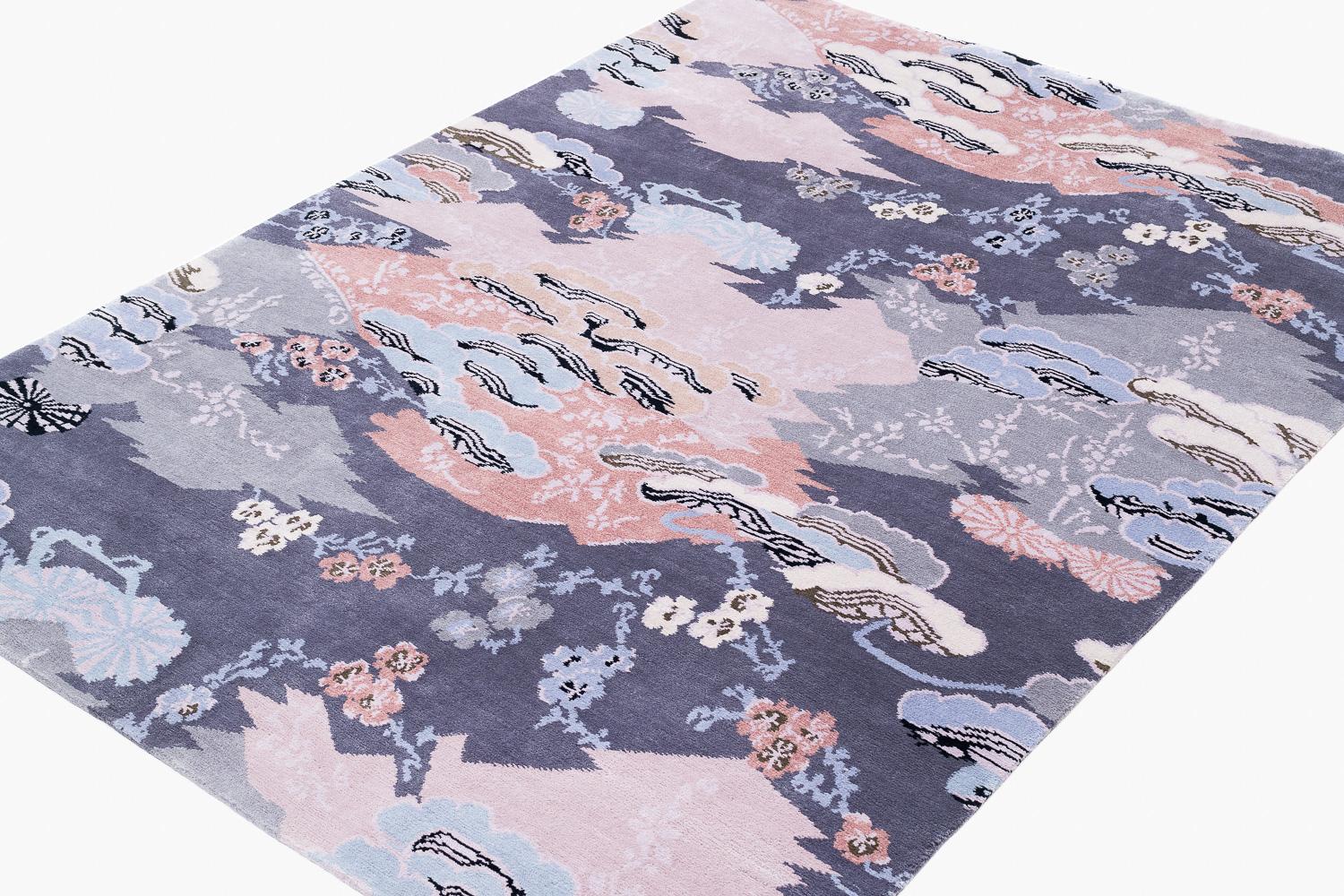 Delicate flowers and Eastern motifs are scattered throughout Mountain Blossom's pastel composition. The field of purple sets off the multicolored designs of pinks, whites, blues, and black in this wool and silk blend carpet. Original design by