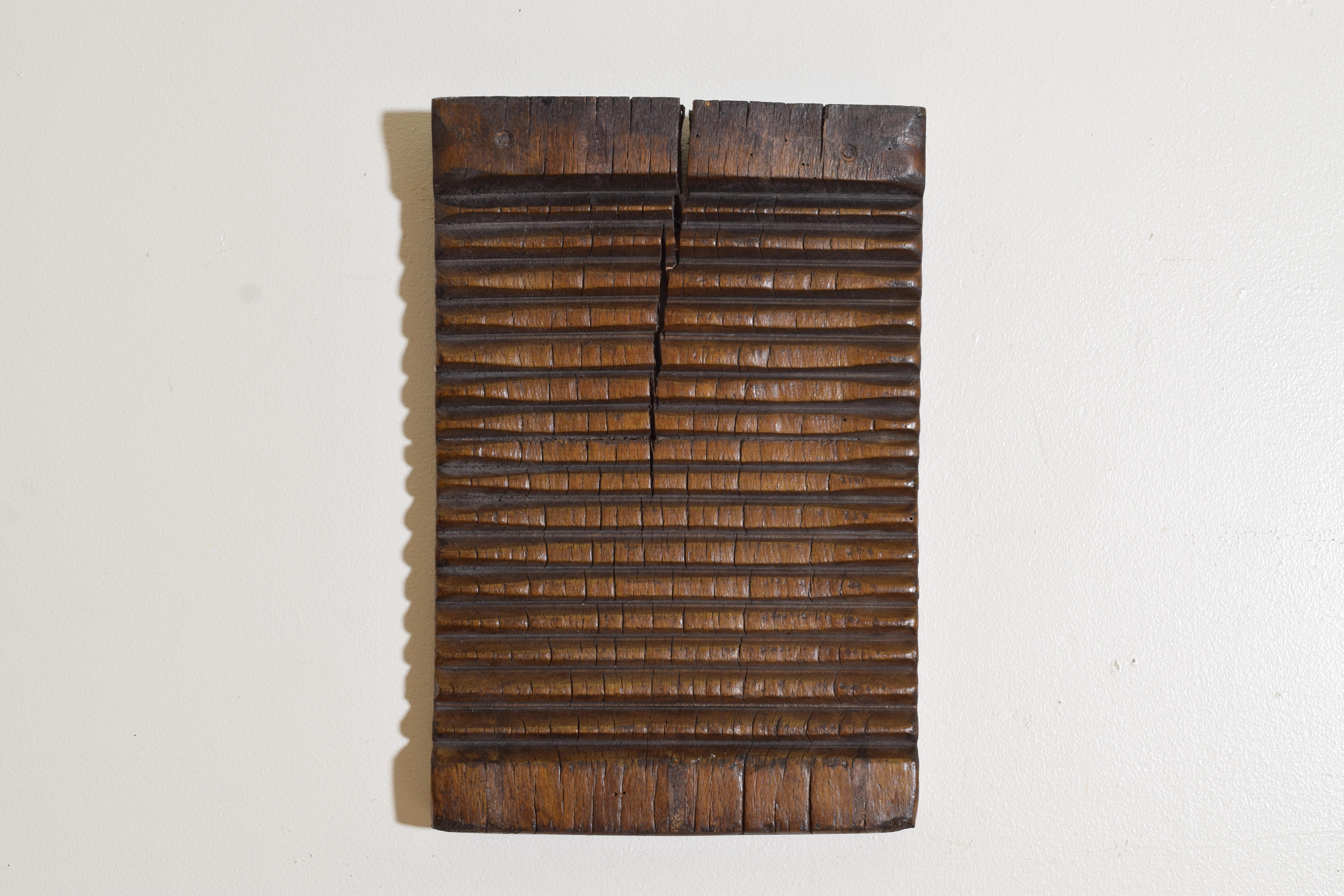 Hand carved in walnut this well worn washboard utilizes both its sides, now best admired as a wall hanging