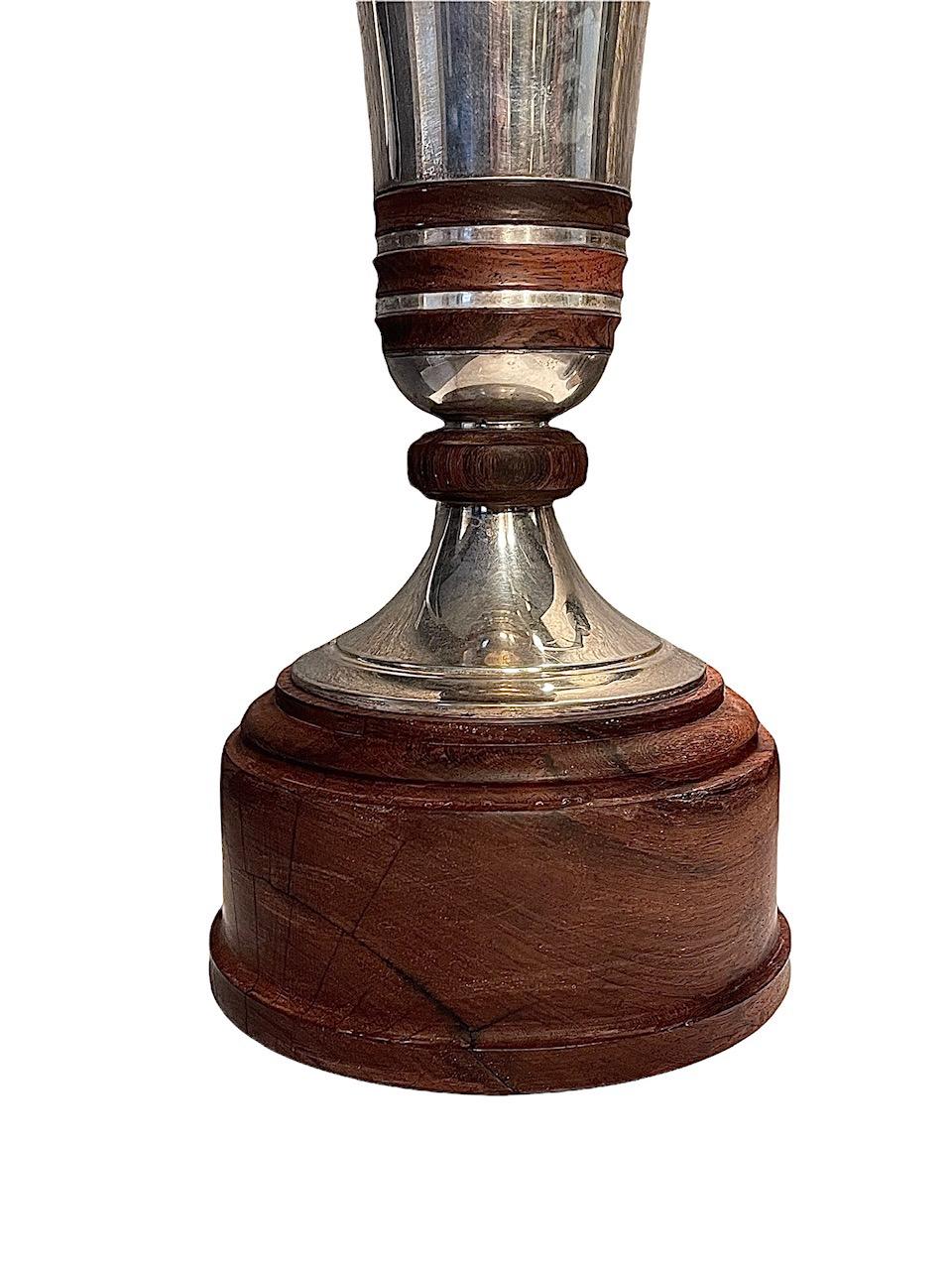A Belgian silver vase on wood stand, by Brussels Wolfers, circa 1950. Trumpet form with wood rings, all affixed to wood base and marked on rim.
 