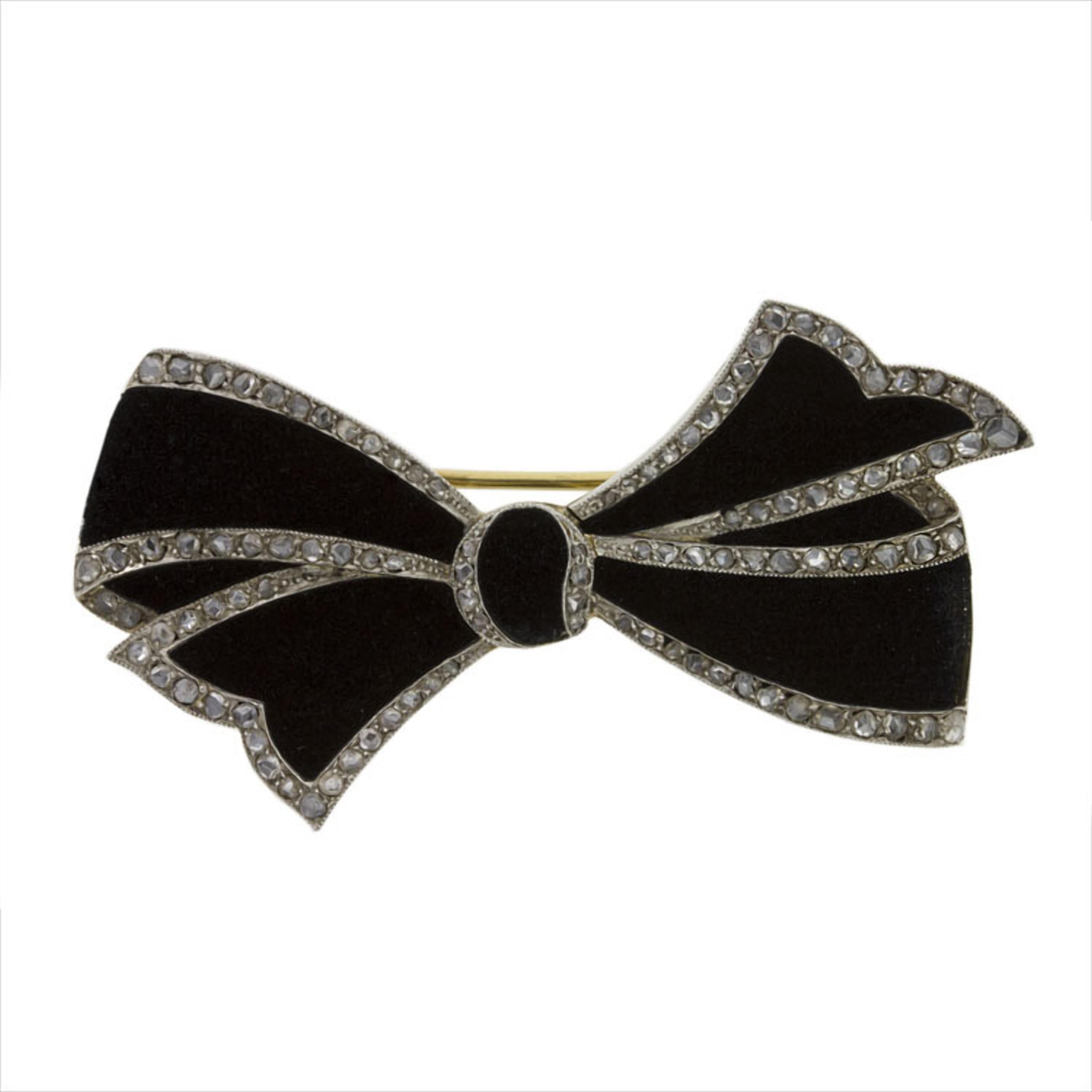 A Belle Epoque diamond bow brooch, the brooch in the form of a tied ribbon bow in black velvet, with rose-cut diamond-set platinum border and yellow gold back, bearing French gold marks and partial maker’s attributed of Cartier, circa 1910,