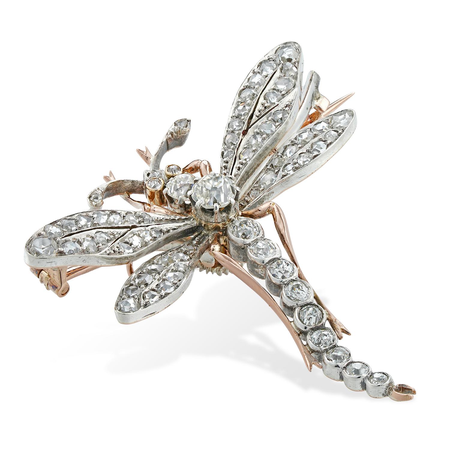 A Belle Epoque diamond-set dragonfly brooch, the body and the head set with fourteen old European-cut diamonds, the wings set with fifty-two rose-cut diamonds, the diamonds estimated to weigh 3 carats in total, all mounted in silver to yellow-gold