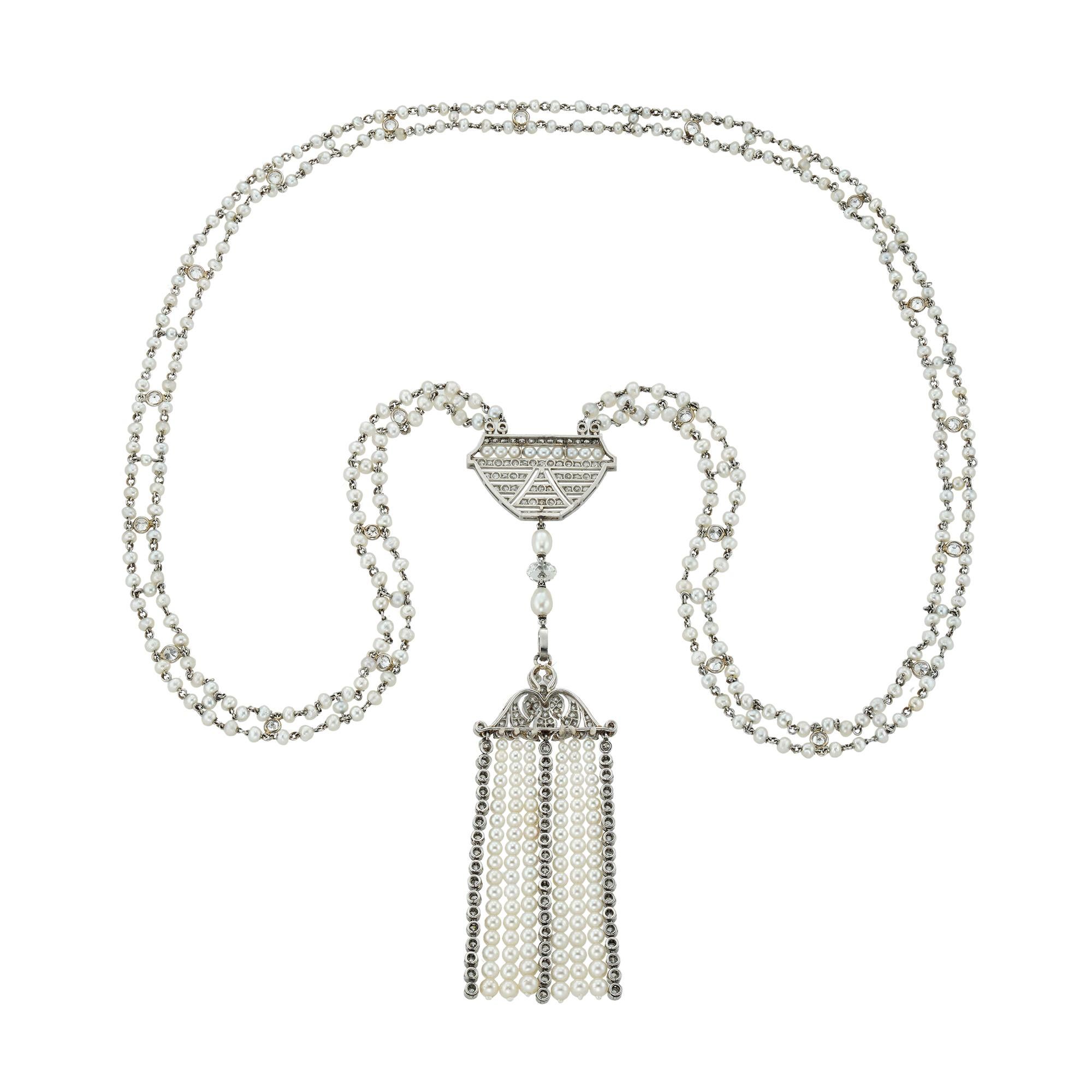 A Belle Epoque natural pearl and diamond sautoir necklace, centred with an openwork plaque of geometric design, encrusted with swiss-cut diamonds and pearls, suspending two pear-shaped pearls and a diamond bead terminating to a tassel, the