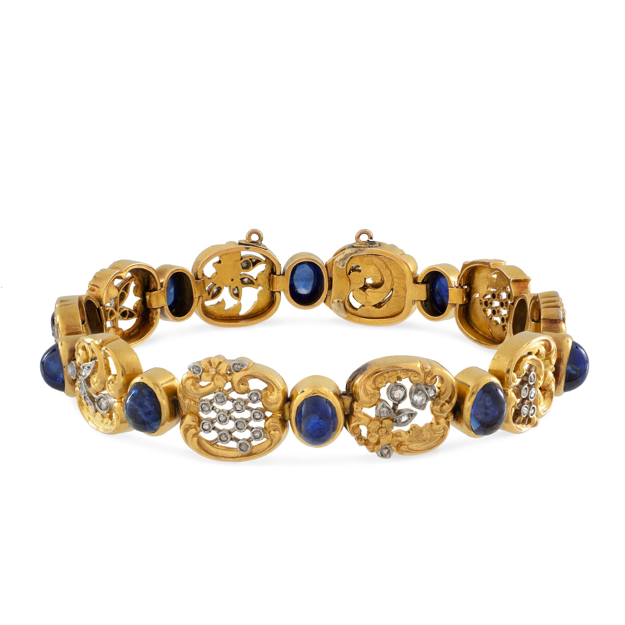 A Belle Epoque sapphire and diamond bracelet, consisting of ten openwork gold and platinum diamond-set carved plaques with foliate and scroll decorations, with ten oval cabochon sapphires with approximate total weight 5 carats rub-over set
