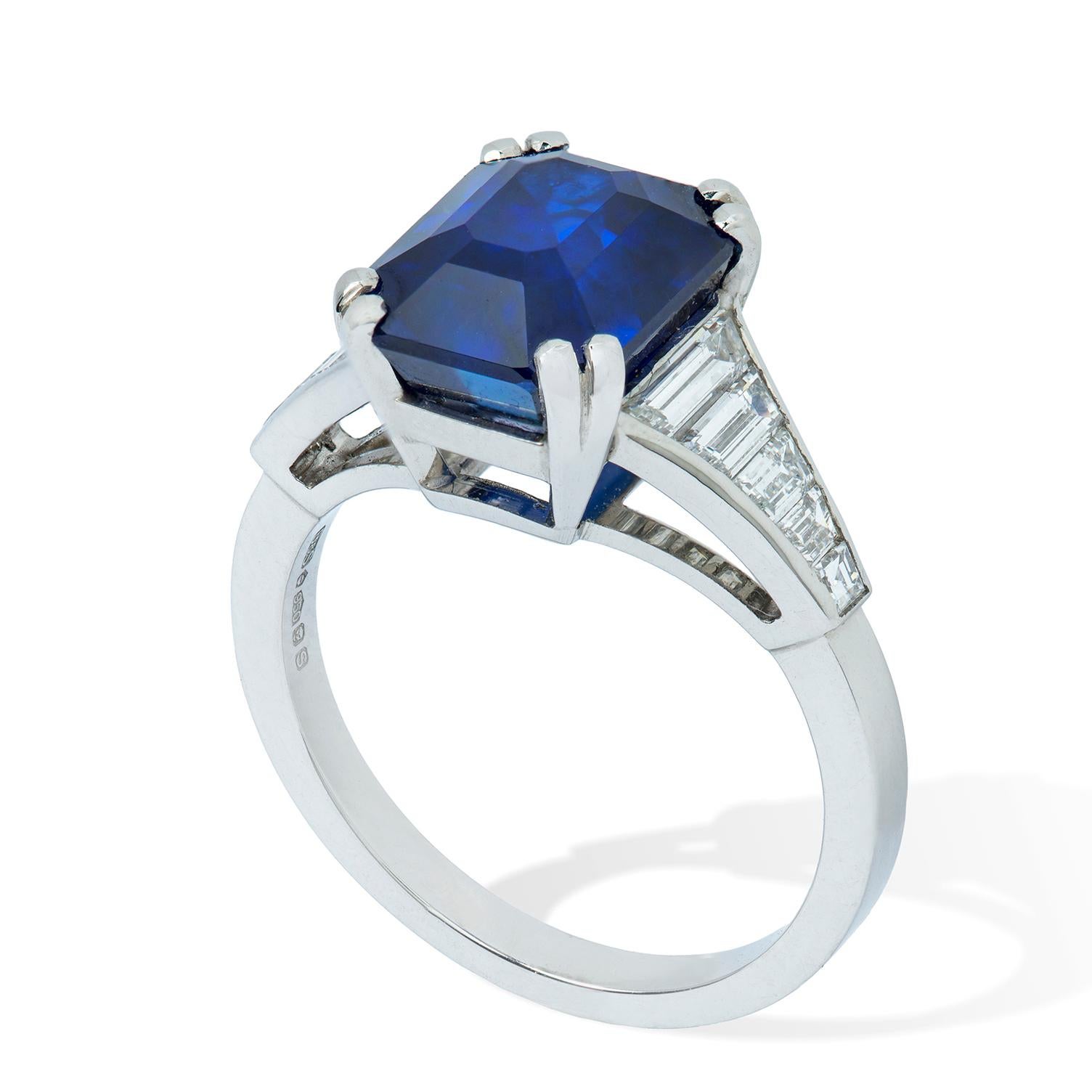 A Bentley & Skinner sapphire and diamond ring, the 5.50 carats octagonal-cut sapphire, accompanied by a GCS Report no: 5777-7895 stating to be natural with no indication of heating, four double-claw set to a platinum collet, with five graduated