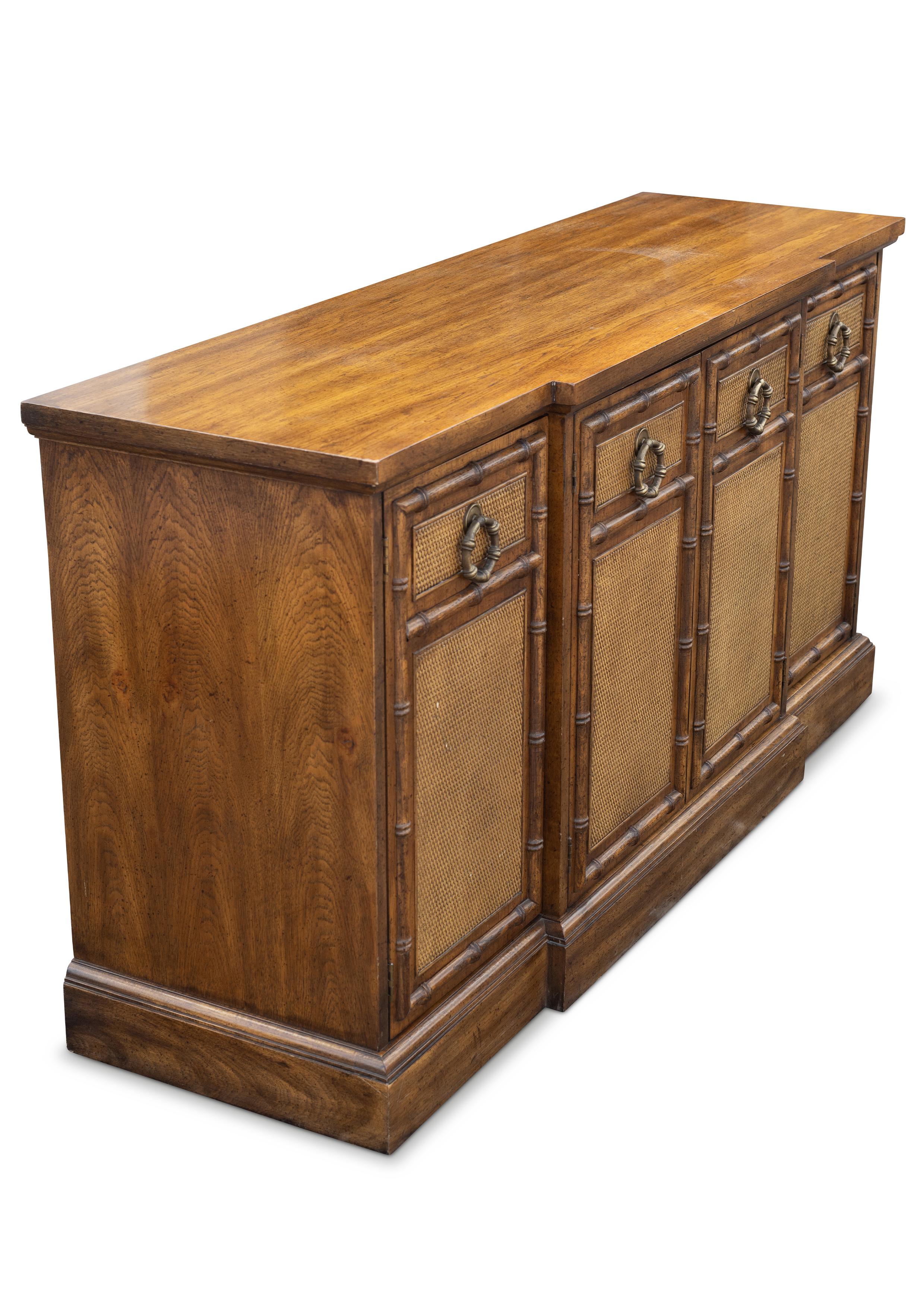 American of Martinsville Bergere and Faux Bamboo Sideboard With Cane sectional fronts and brass handles.

Founded in 1906, American of Martinsville was founded by Virginia tobacco producers and produces bedroom furniture. In the early 1920s the