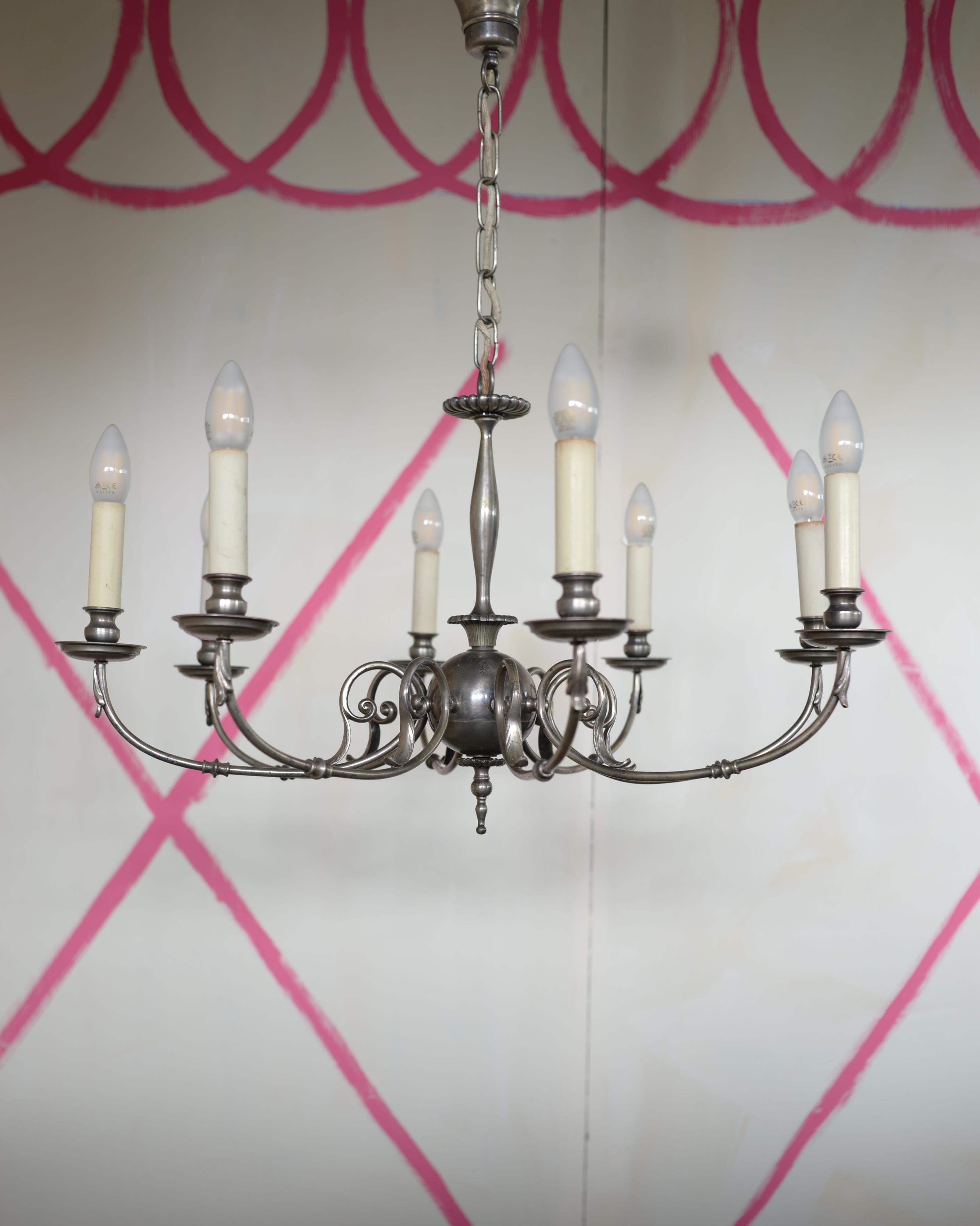 A Berlin Deko eight light chandelier made of a silver toned alloy, echoing the appearance of pewter. Most likely by Vereinigte Werkstätten für Kunst im Handwerk, circa 1919.

A founding member of the Vereinigte Werksstätten für Kunst im handwerk was