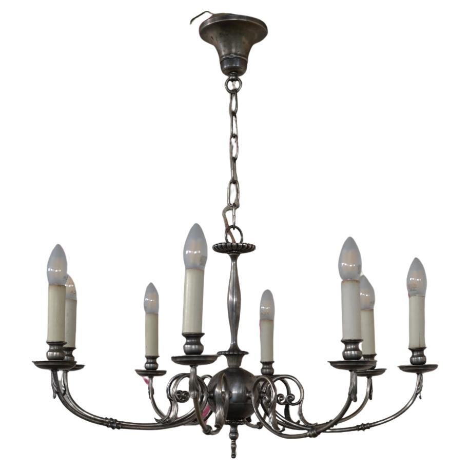 A Berlin Deko Eight Light Chandelier Made of a Silver Toned Alloy