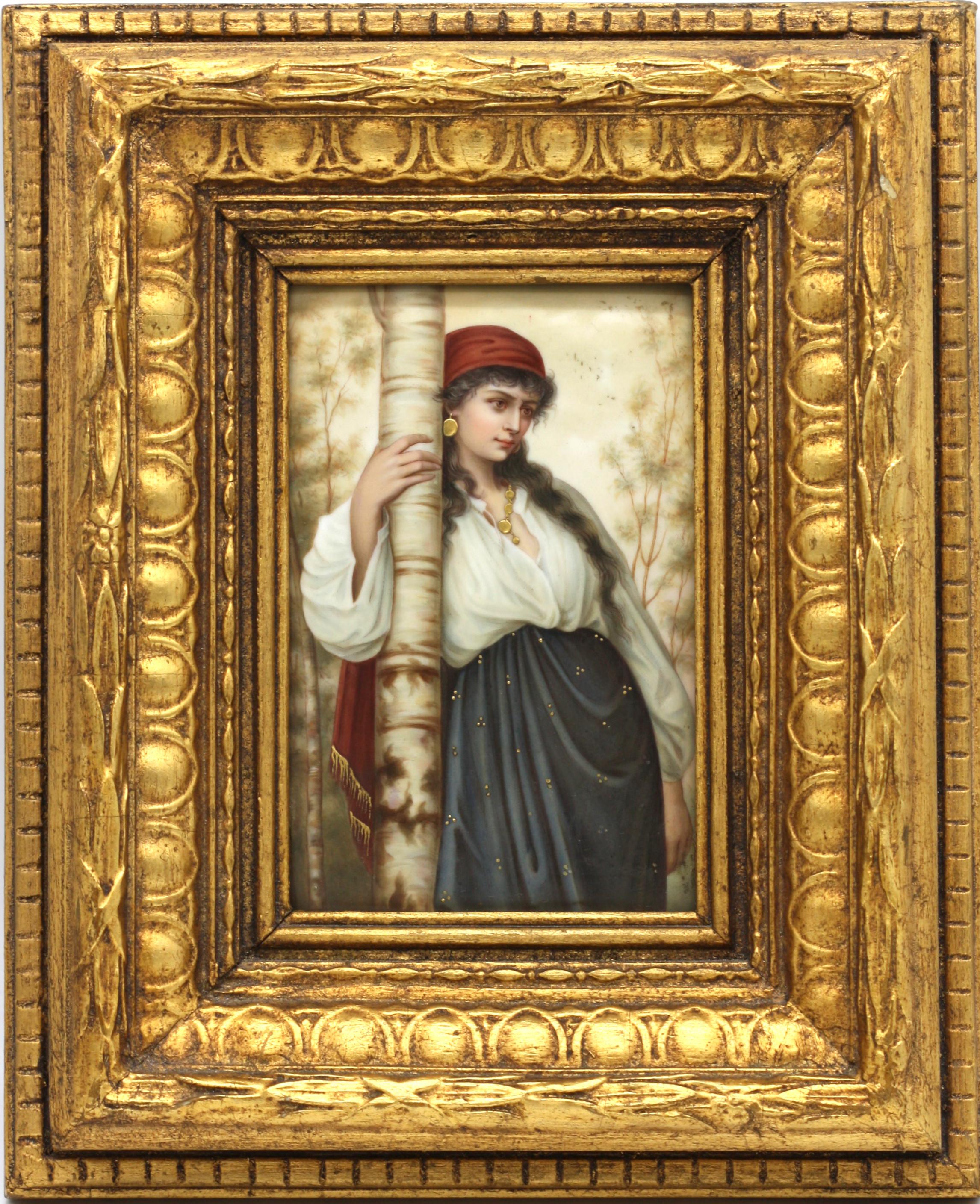 A Berlin (KPM) style porcelain plaque, circa 1880
painted with a gypsy girl standing beside a tree with gilt highlights, in a later giltwood frame, size with frame 10 x 8 in. (25.4 x 20.32 cm.).
 