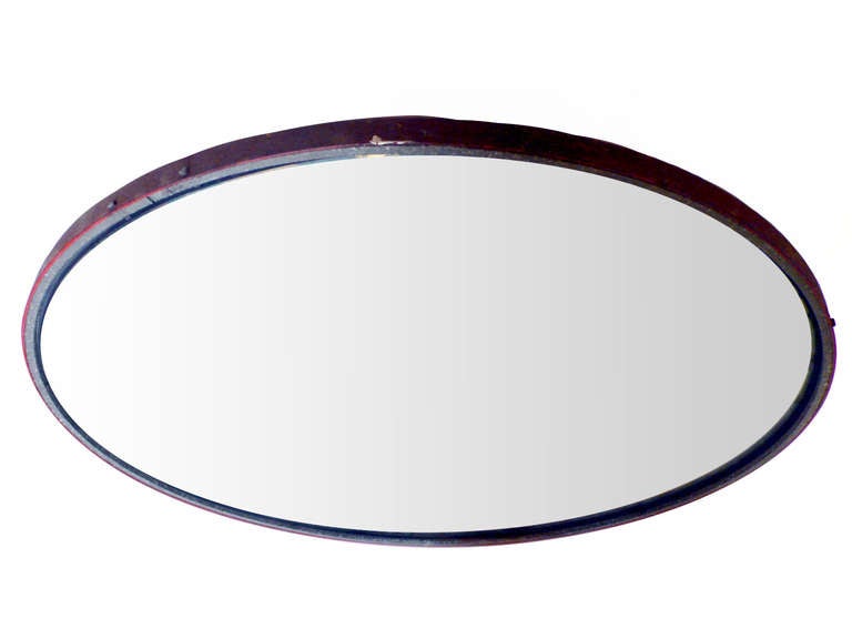 One industrial element. A big round convex road’s mirror, mounted on an iron frame.