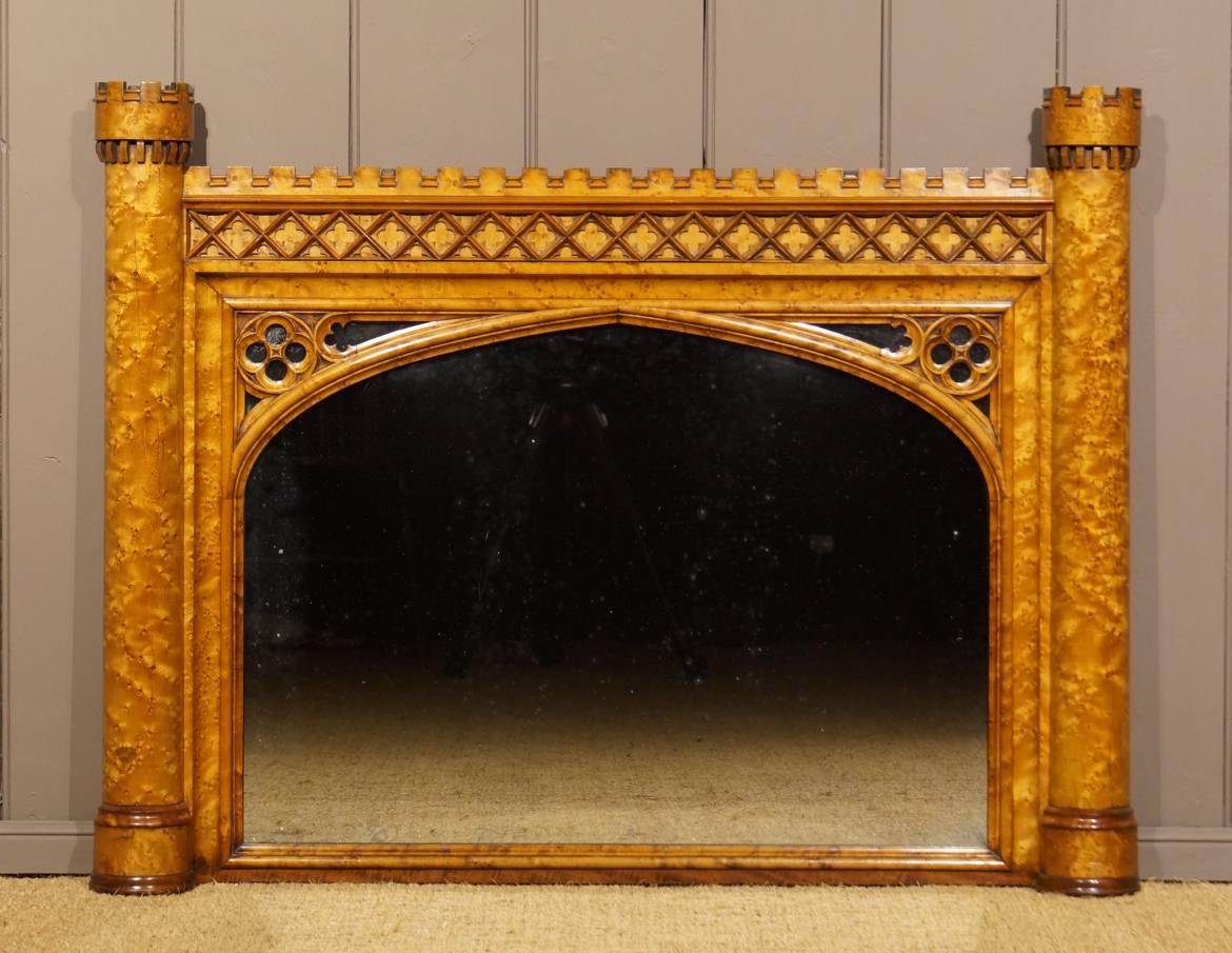 This stunning and extremely rare mirror is one of the finest examples of the English Regency period in the Gothic and Romantic Medieval taste. Made of highly figured bird’s-eye maple it shows remarkable similarities to the designs in this genre to